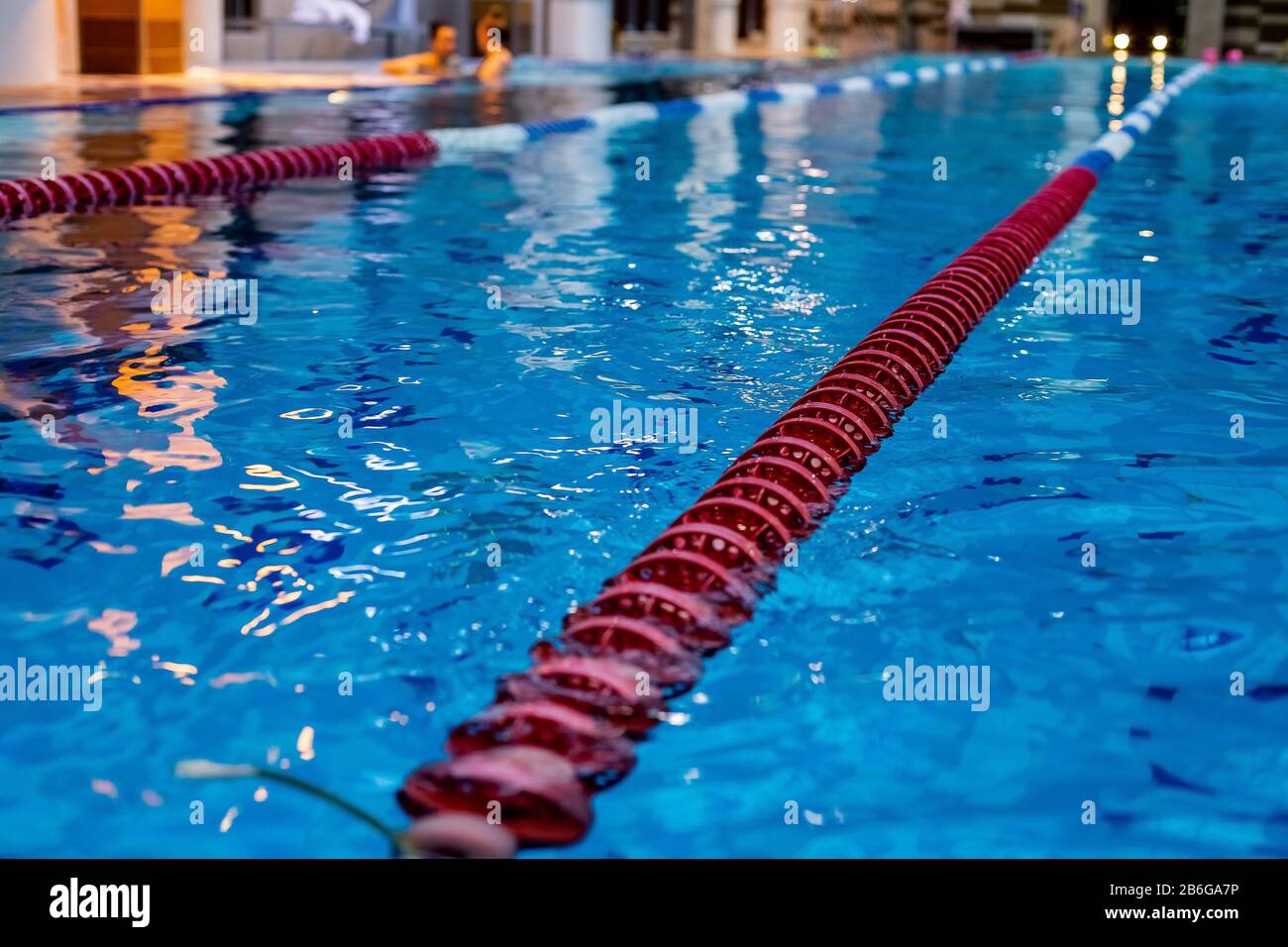 red Swimming Lane Marker in swimming pool.Color-fast swimming pool lane  line.Lane ropes in swimming pool.red plastic rope lane on blue water indoor  Stock Photo - Alamy