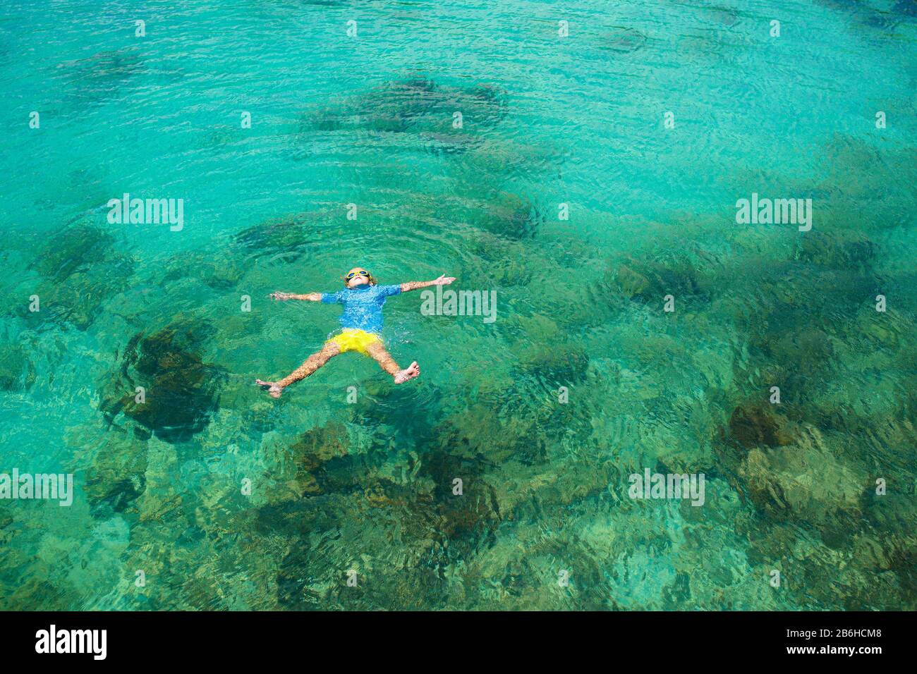 Kids snorkel. Beach fun. Children snorkeling in tropical sea on family summer vacation on exotic island. Child with mask and fins. Travel with young k Stock Photo