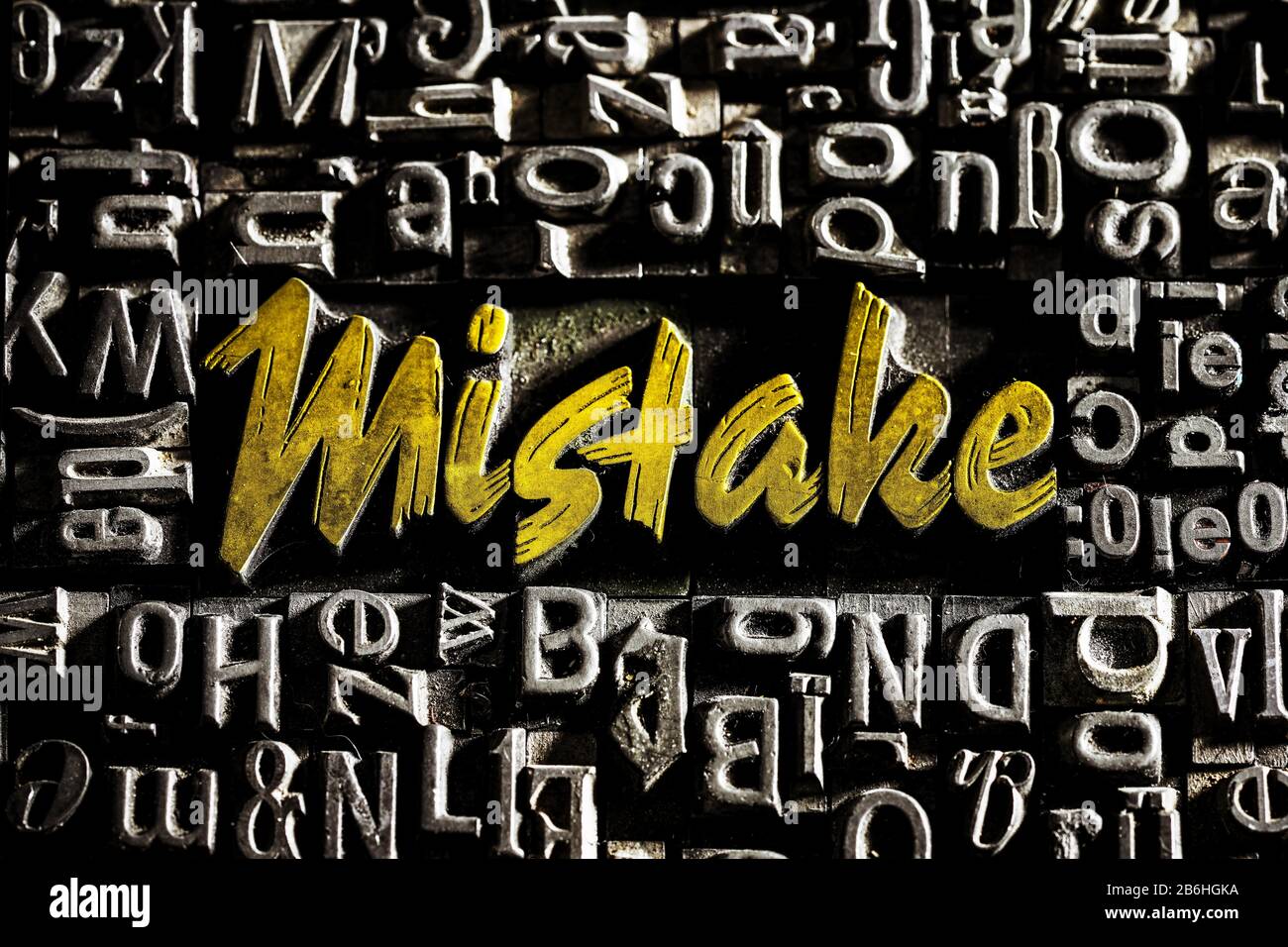 Old lead letters with golden writing show the word Mistake, Germany Stock Photo