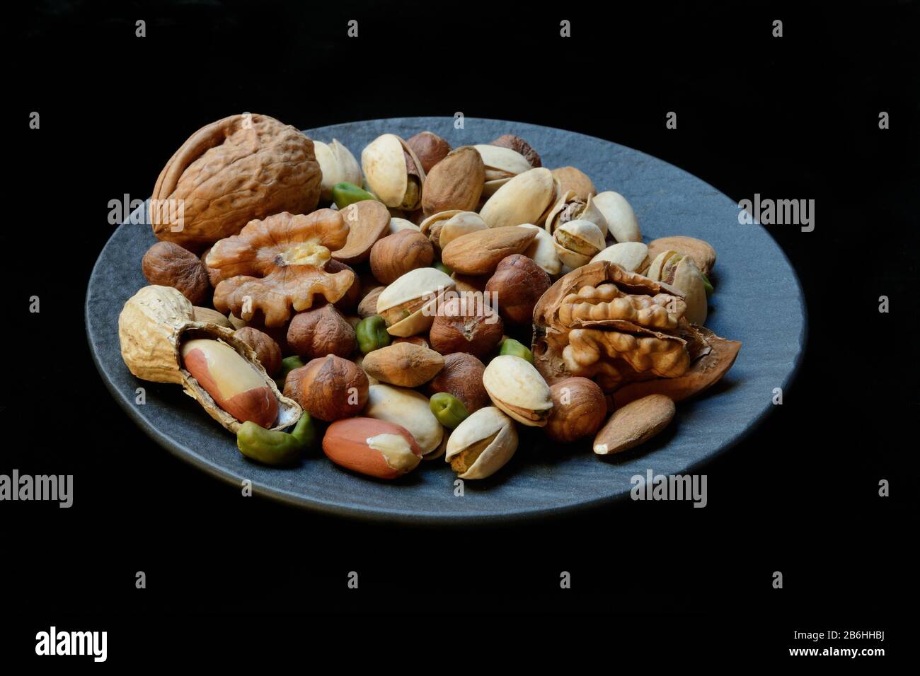 Various nuts on plates, Germany Stock Photo