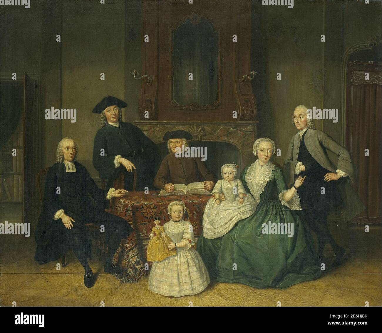 The Amsterdam Mennonite Brak Family, SK-A-2136 Family Portrait Of The Amsterdam Mennonite Brak family in an interior sitting around a table for a mantelpiece. From left to right: Reverend Jan Beagle (1717-61), his brother Peter Beagle (ca. 1714-after 1778), his father Harmen Beagle (died 1768)., His sister Margaret Hasselaar (1726-80 / 83) with its husband Cornelis Beagle (1724-82). Standing in the foreground is their eldest daughter with a doll, Margaretha (born in 1752) sits on her mother's lap. Left a view through to the bibliotheek. Manufacturer : painter: Tibout Regters (listed building) Stock Photo
