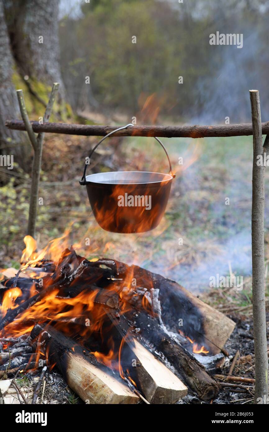 Cauldron or camping kettle over open fire outdoors Stock Photo - Alamy