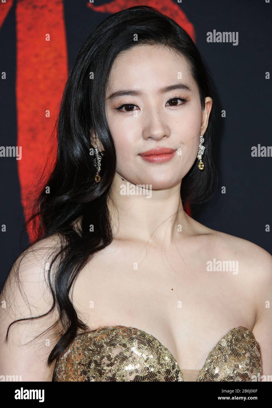 Hollywood, United States. 09th Mar, 2020. HOLLYWOOD, LOS ANGELES, CALIFORNIA, USA - MARCH 09: Actress Yifei Liu (Crystal Liu) wearing a shimmering gold, strapless gown embroidered with golden silk threads and sequins, accentuated by a grandeur train from the Elie Saab Fall/Winter 2019 Haute Couture Collection and Chaumet jewelry arrives at the World Premiere Of Disney's 'Mulan' held at the El Capitan Theatre and Dolby Theatre on March 9, 2020 in Hollywood, Los Angeles, California, United States. (Photo by Xavier Collin/Image Press Agency) Credit: Image Press Agency/Alamy Live News Stock Photo