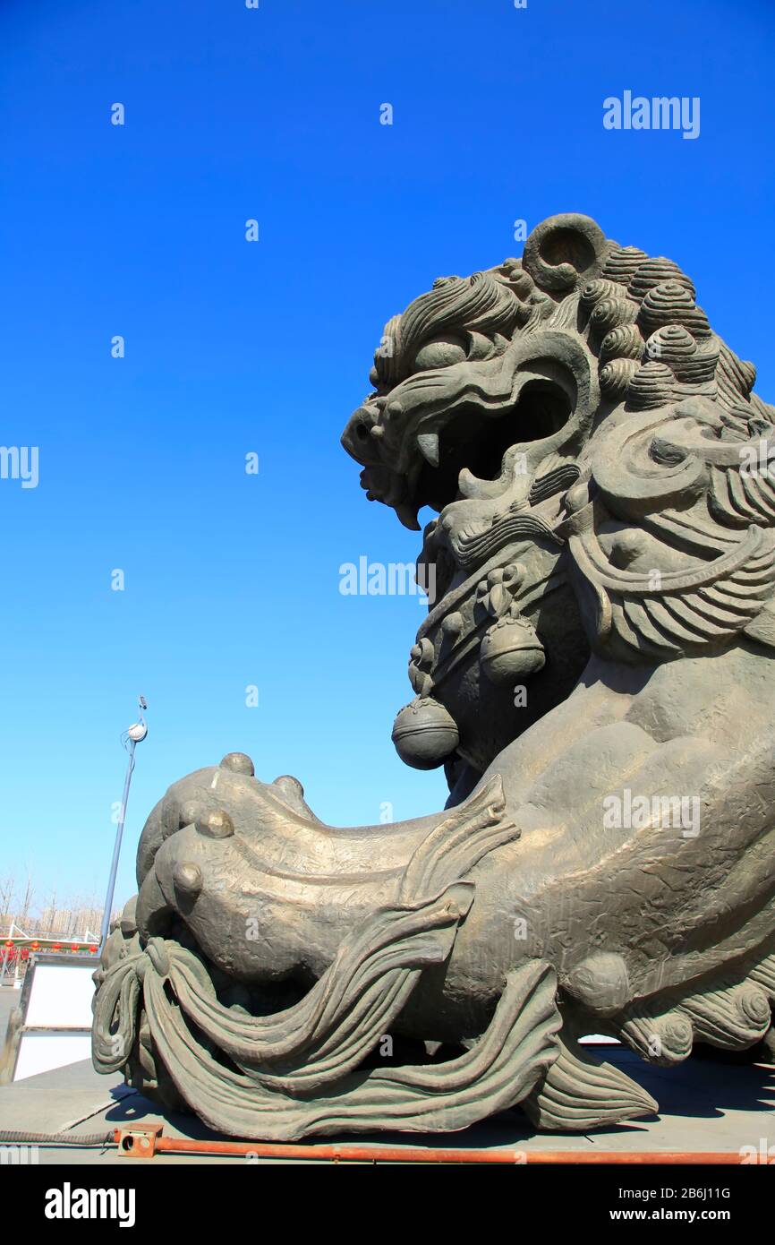 Bronze lion under the blue sky Stock Photo - Alamy