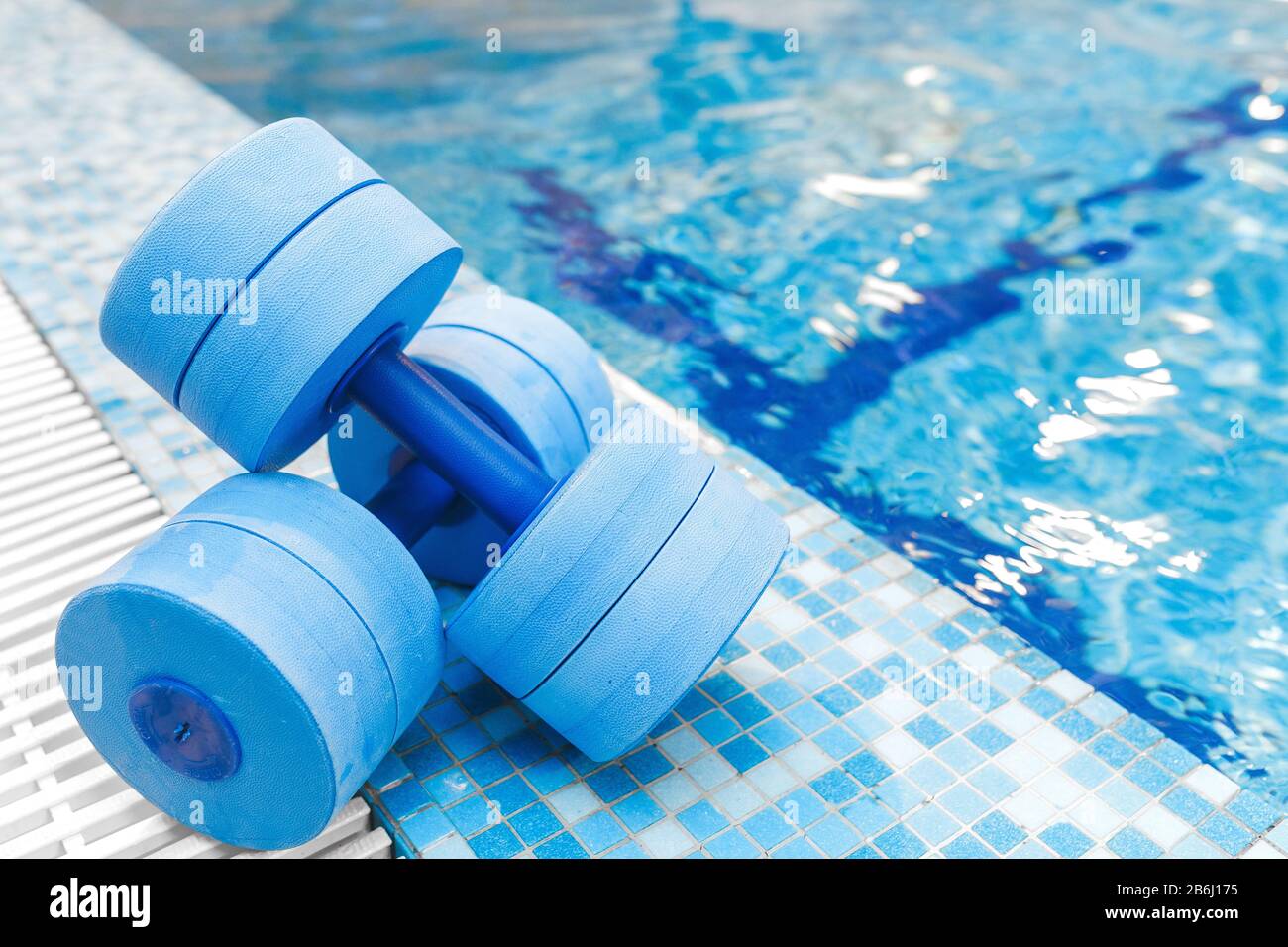 dumbbells equipment for aqua aerobics sport near swimming pool Stock Photo  - Alamy