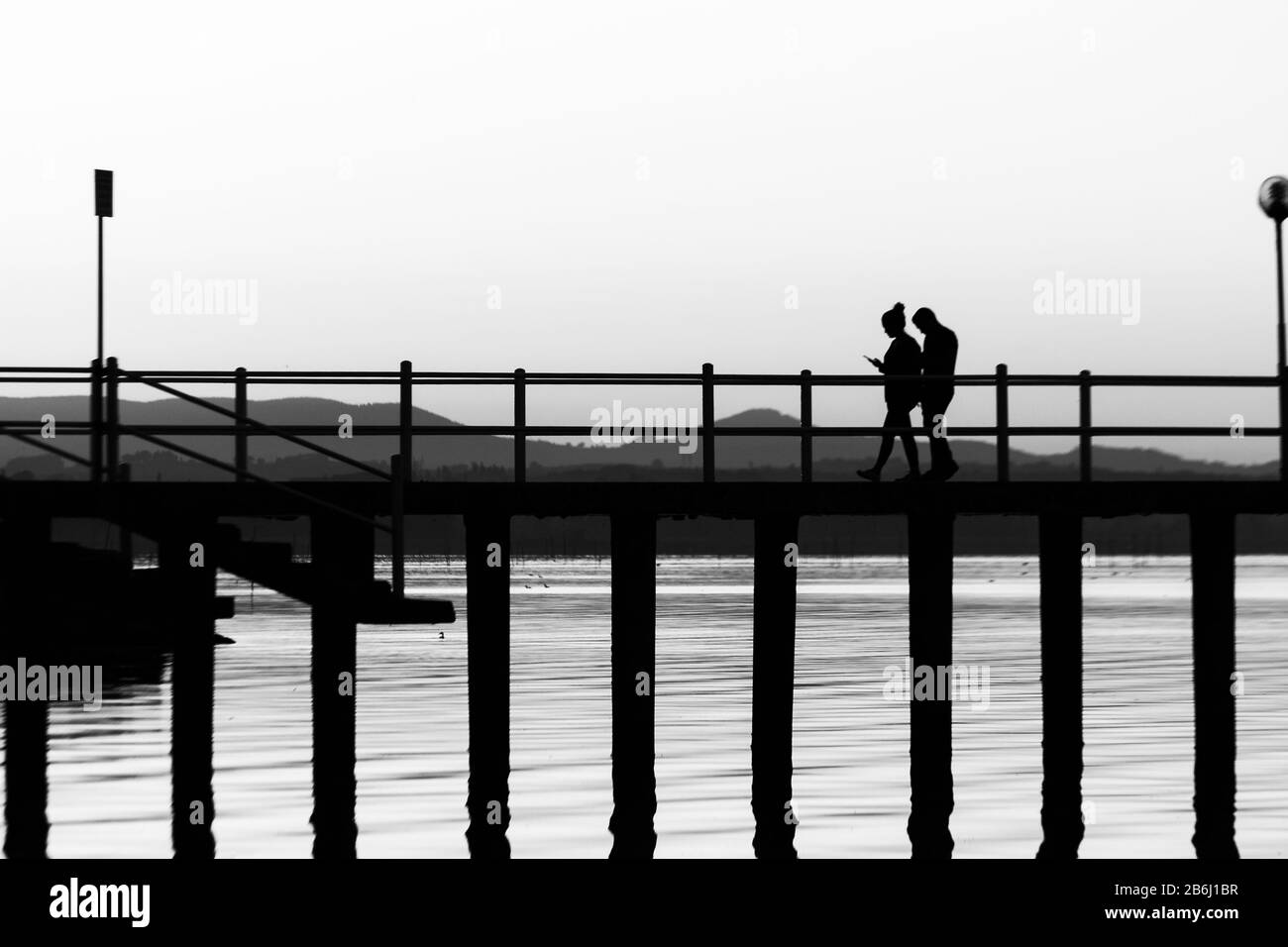 Two people walking Black and White Stock Photos & Images - Alamy