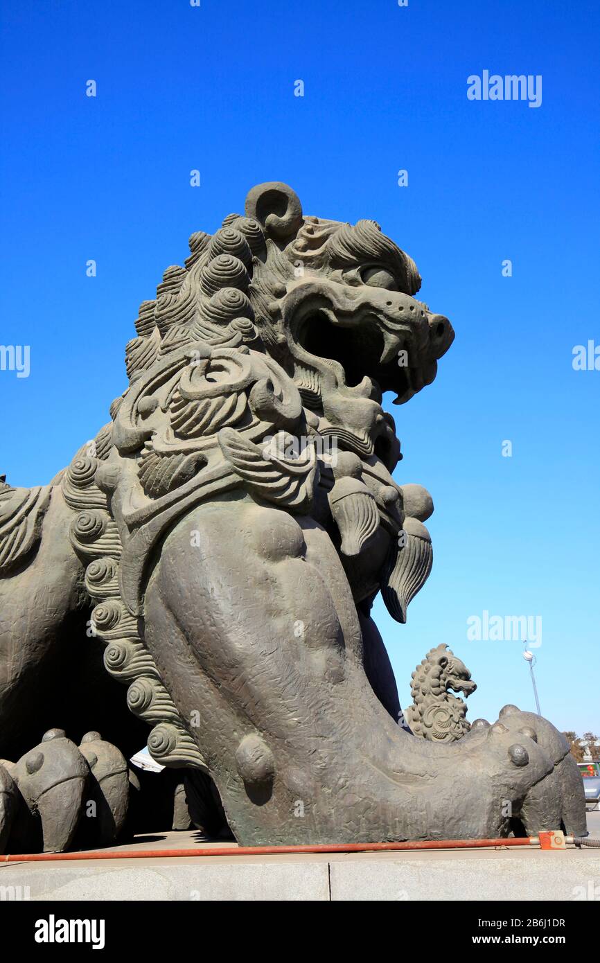 Bronze lion under the blue sky Stock Photo - Alamy