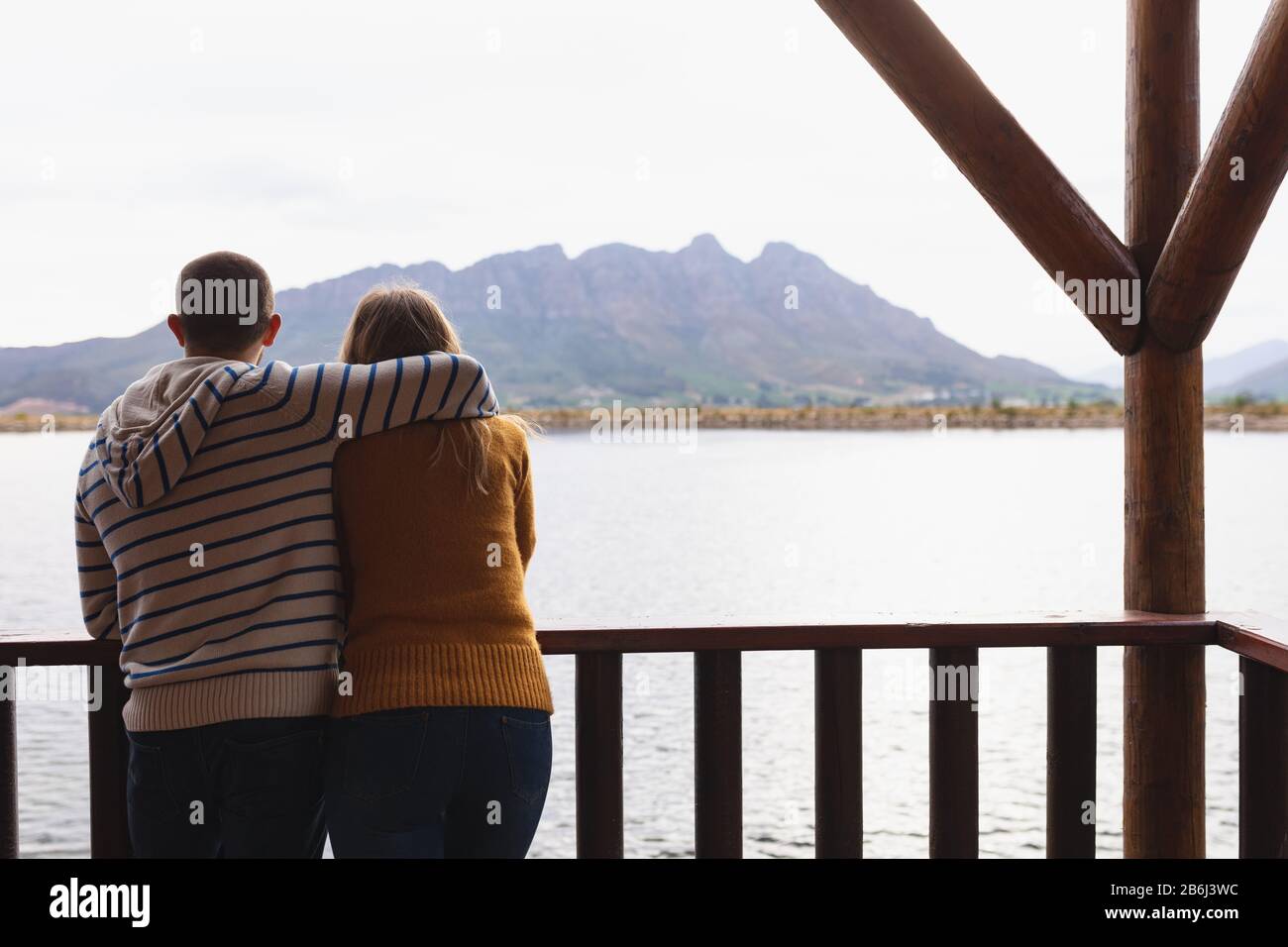 Caucasian couple watching the view and cuddling Stock Photo