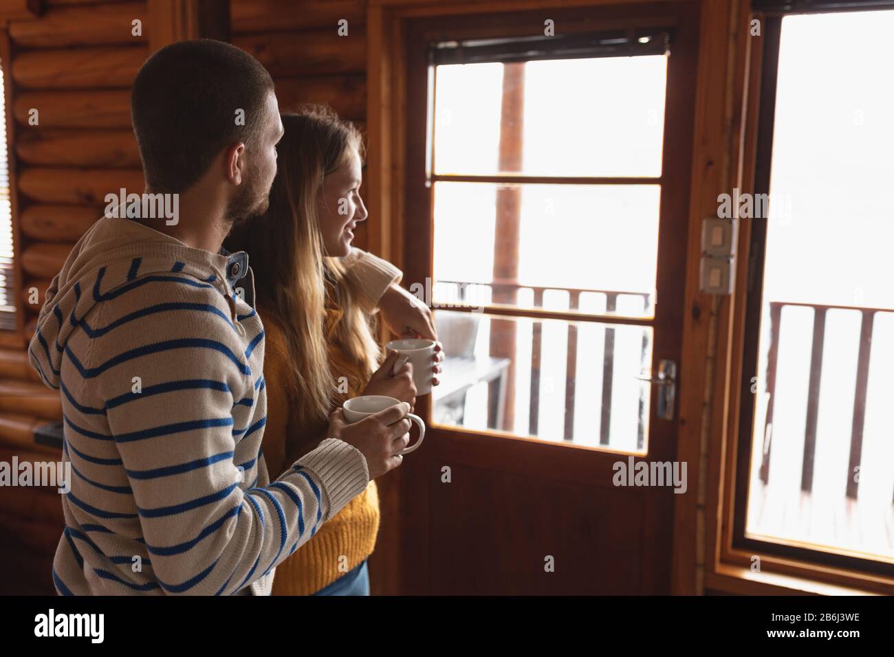 Caucasian couple watching outdoors view and holding a mug Stock Photo