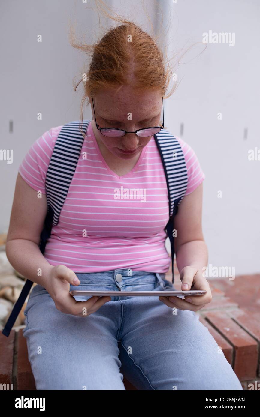 Front view of student using a touch pad outside Stock Photo
