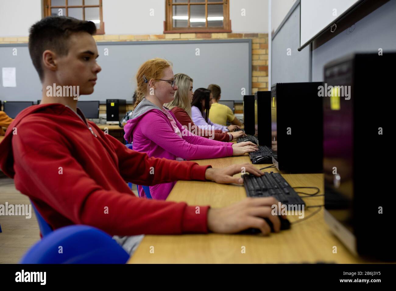 Side view of students working on computers Stock Photo - Alamy