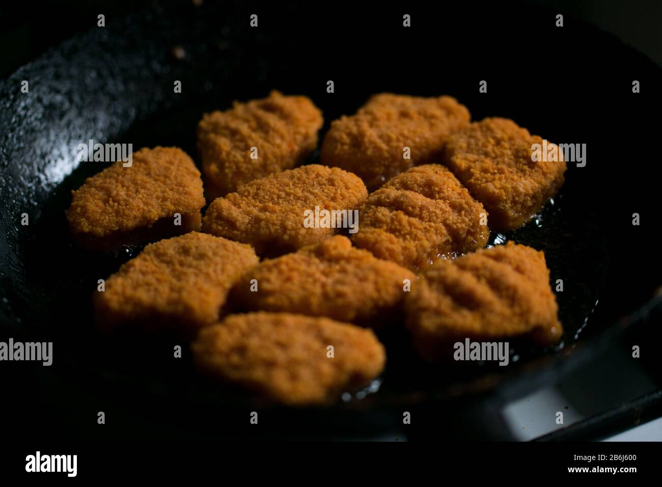 Golden chicken nuggets frying in hot oil black dark pan Stock Photo Alamy