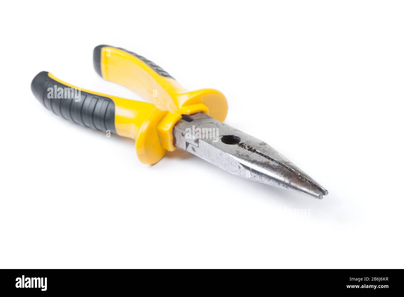 Old pliers with yellow handle isolated on white background Stock Photo