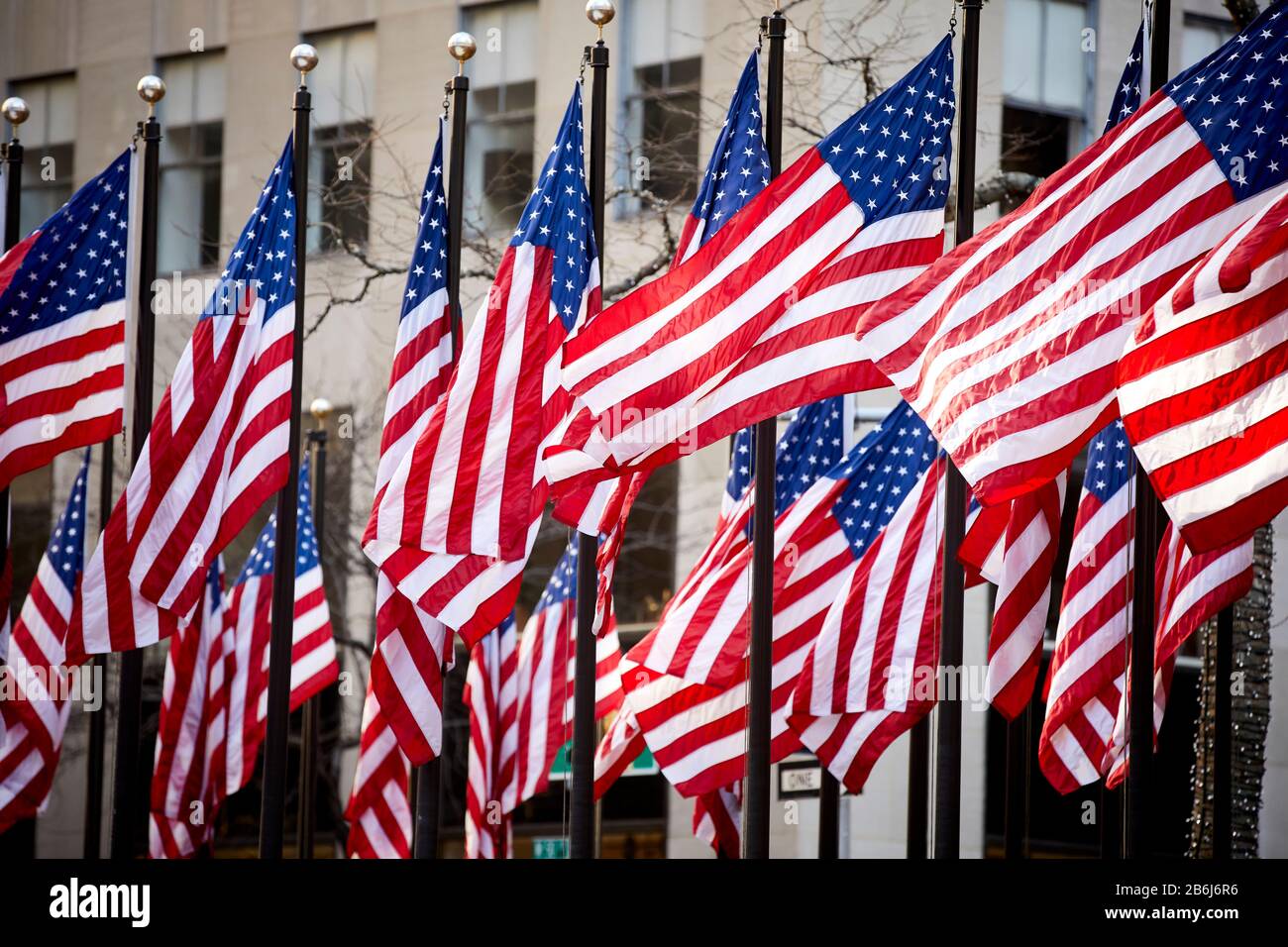 New York city Manhattan numerous American Starts and Stripes flags on flagpoles at Rockefeller Center Stock Photo