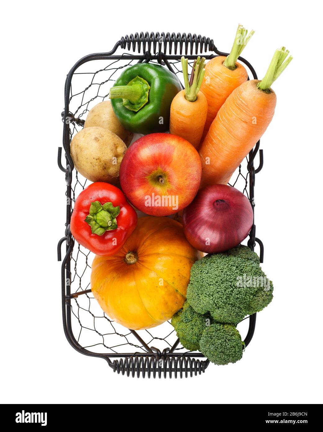 Various fresh vegetables and fruits in a wire basket. Isolated on white. Stock Photo