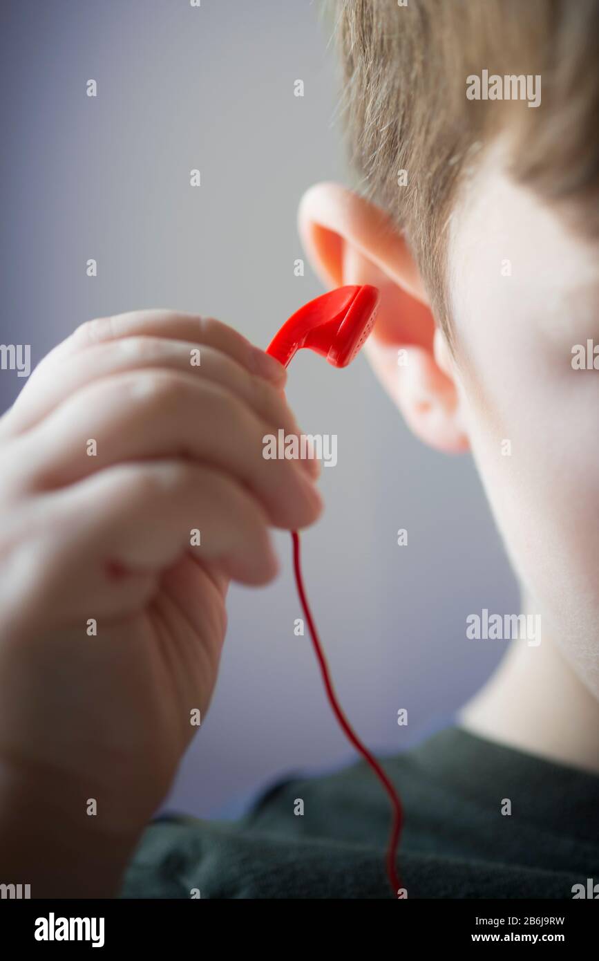 Child Takes off the Hear Phones Stock Photo