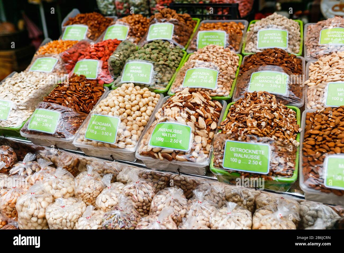 Various kinds of dried nuts with price tags in German language on