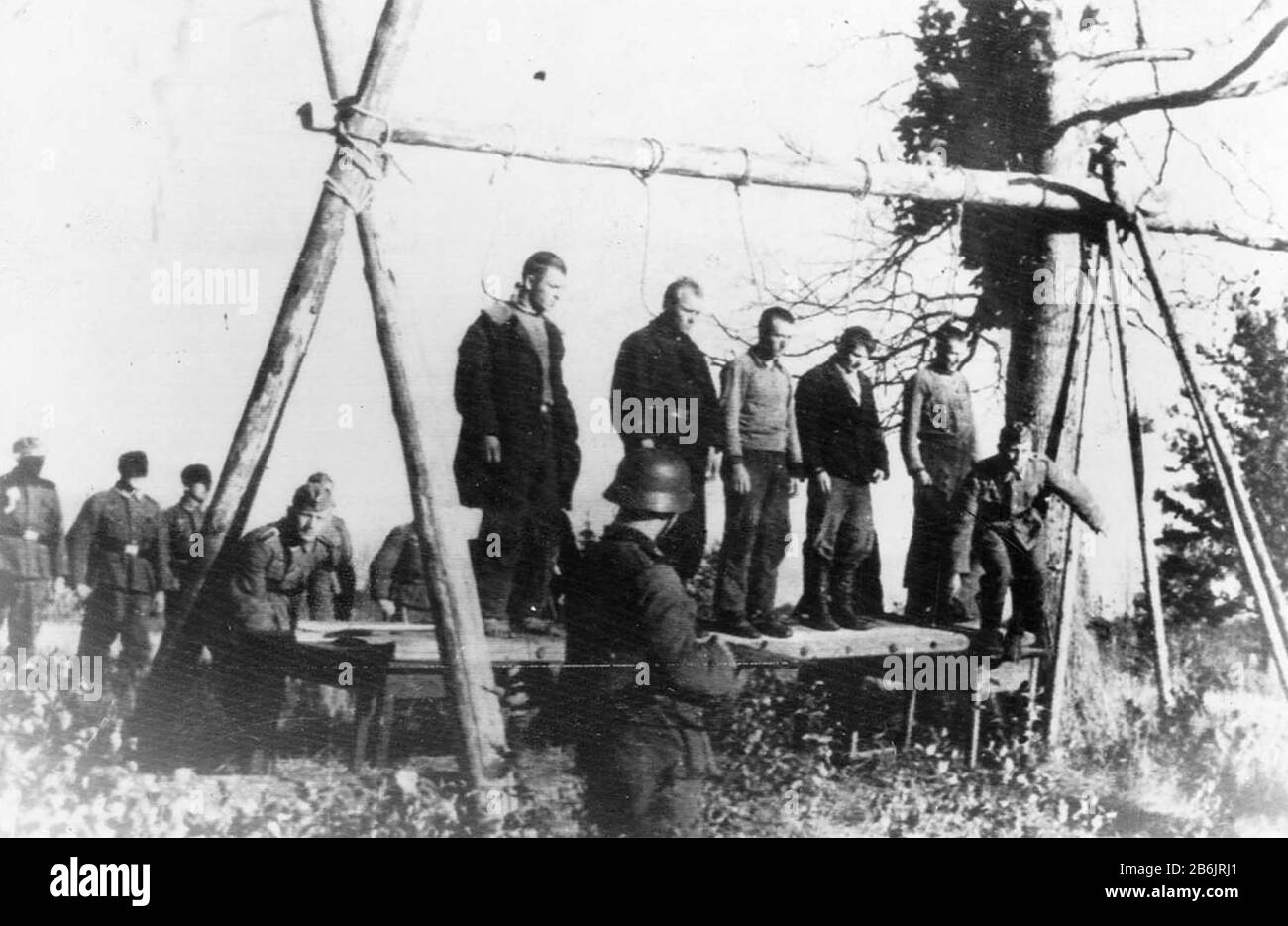 GERMANS HANG SOVIET CIVILIANS. Five Russians await hanging near the town of Velizh in the Smolensk region of NW Russia in September 1941. German soldiers await the order to tip over the makeshift platform while the next group to be executed stand behind blindfolded. In September 1942 German occupation forces murdered all but 17 of the town's 1440 Jewish population. Stock Photo