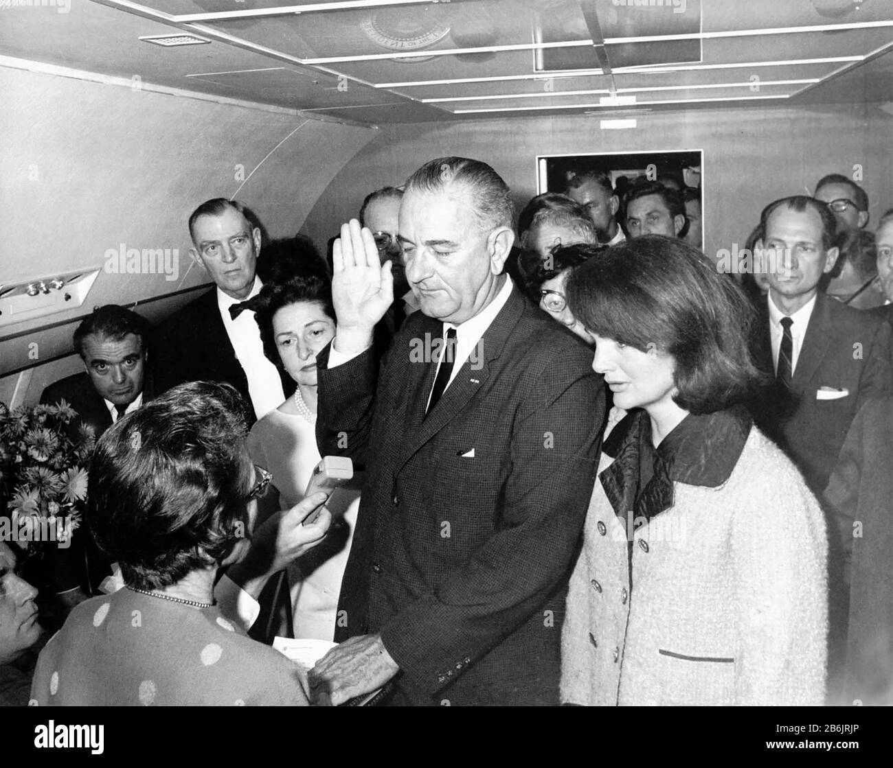 LYNDON B. JOHNSON is sworn in as US President aboard Air Force One on 22 November 1963 flanked by his wife at left and Jackie Kennedy. Photo: Cecil Stoughton Stock Photo