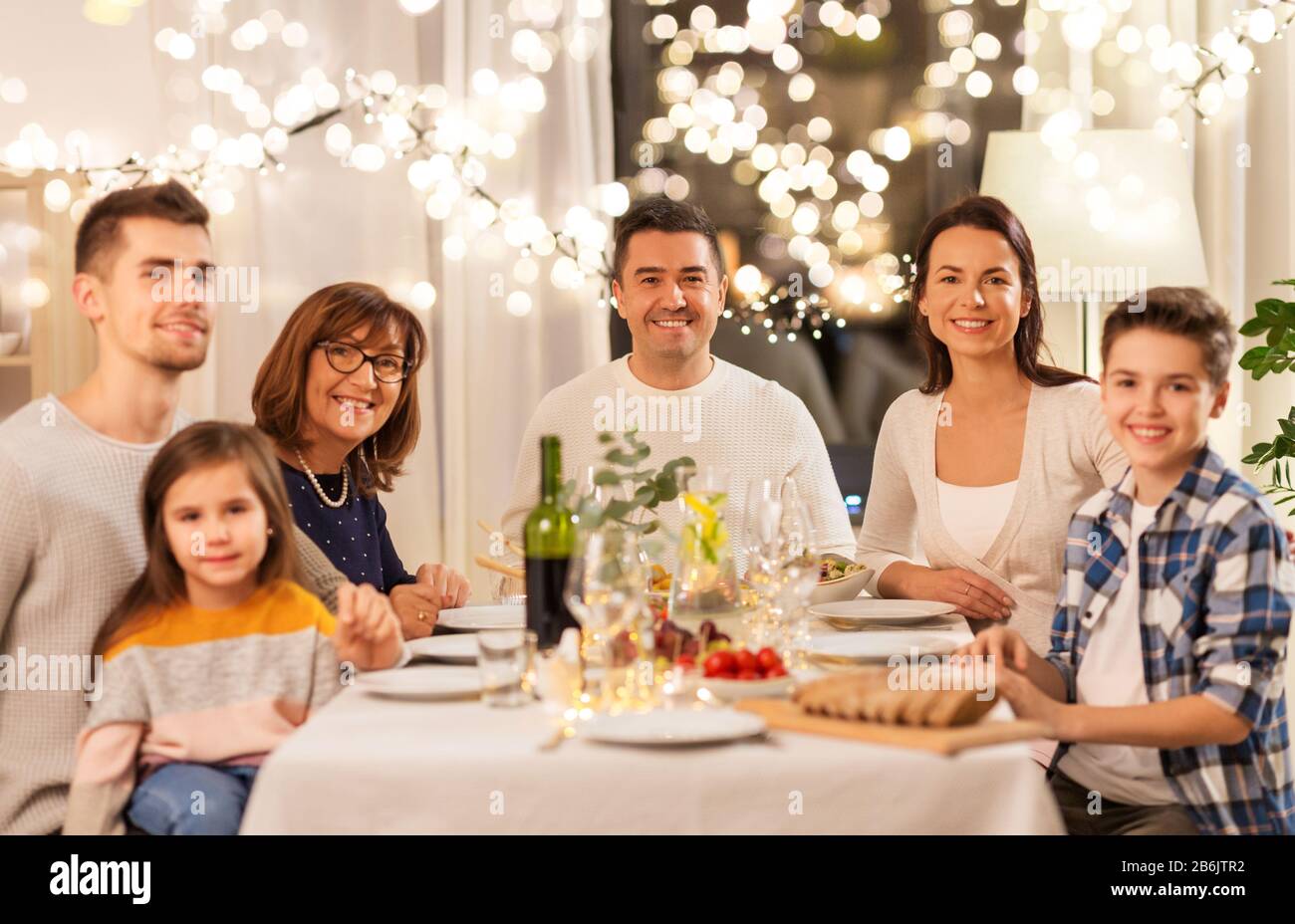 celebration-holidays-and-people-concept-happy-family-having-dinner