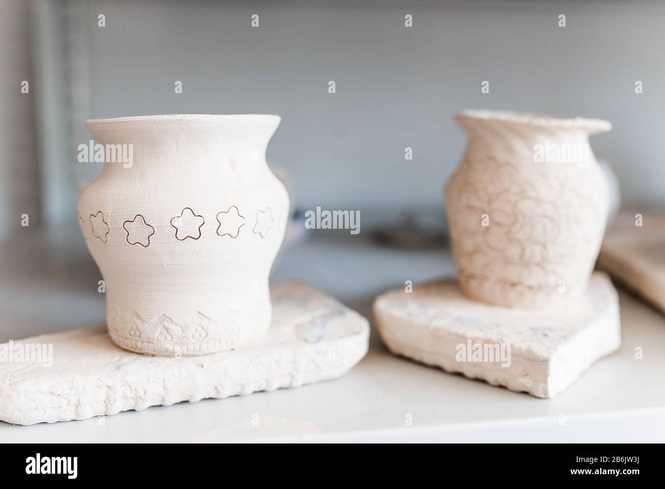 Empty clay pots drying on a shelf Stock Photo