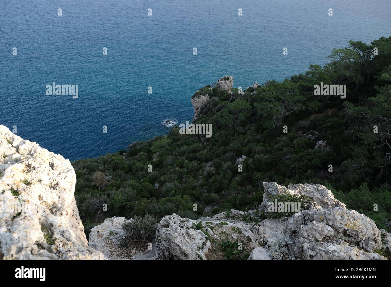Landscape with high mountains covered with dense southern vegetation and wonderful clean turquoise sea water sea far below Stock Photo
