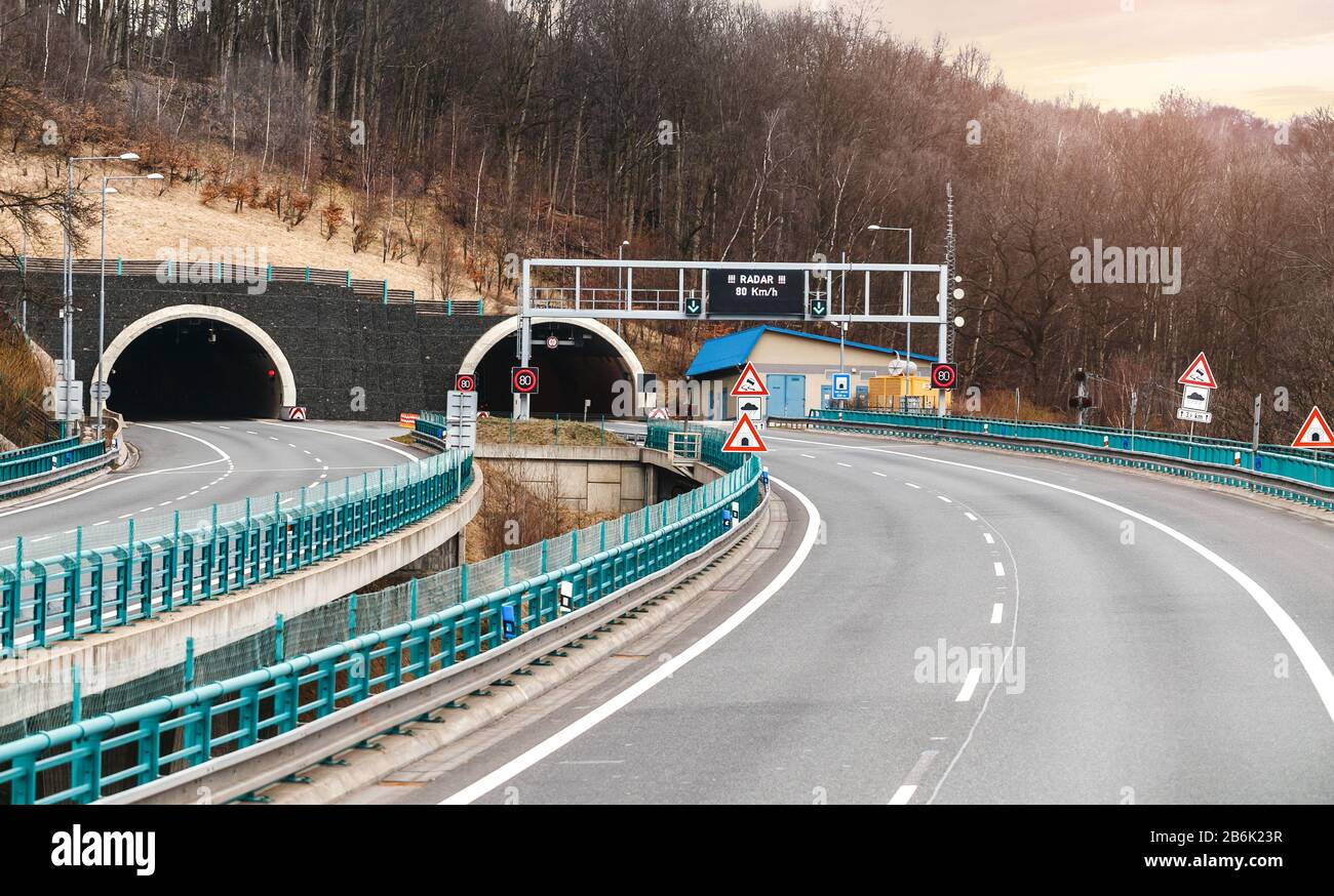 A large road tunnel in Europe with a maximum speed limit sign Stock