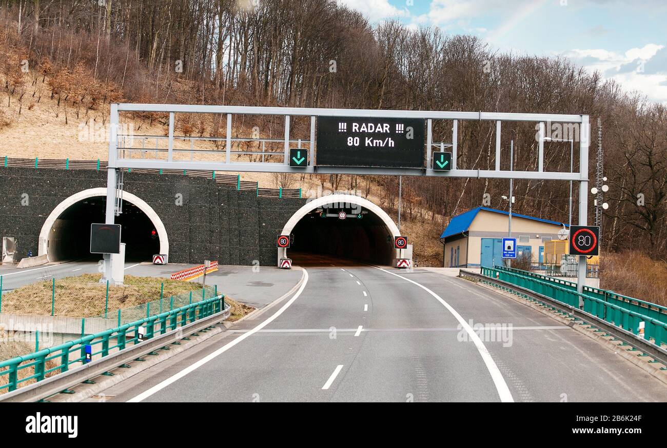 A large road tunnel in Europe with a maximum speed limit sign Stock