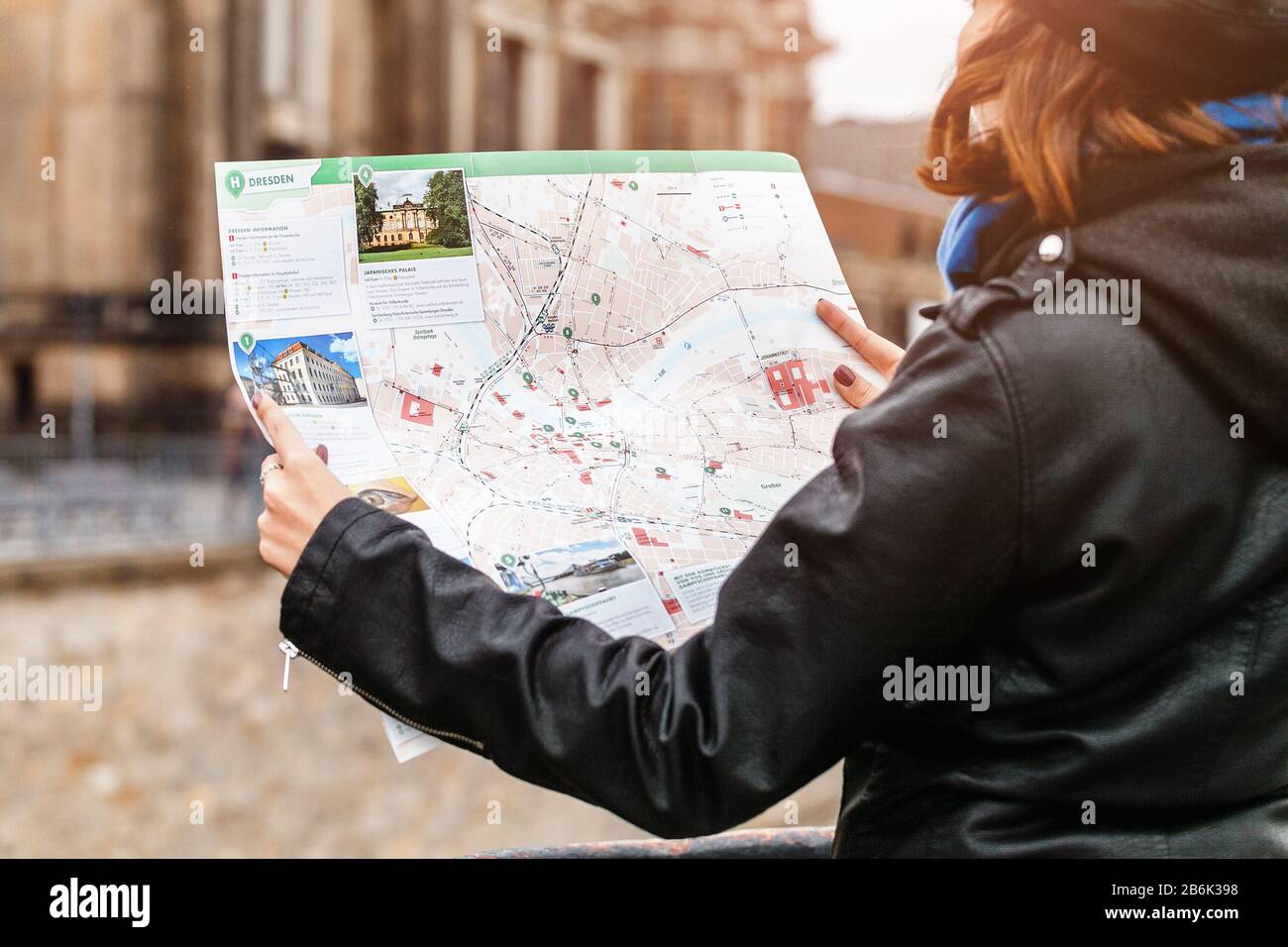 DRESDEN, GERMANY, MARCH 21, 2017: Woman looking to the map of Dresden in the old city street, closeup shot Stock Photo
