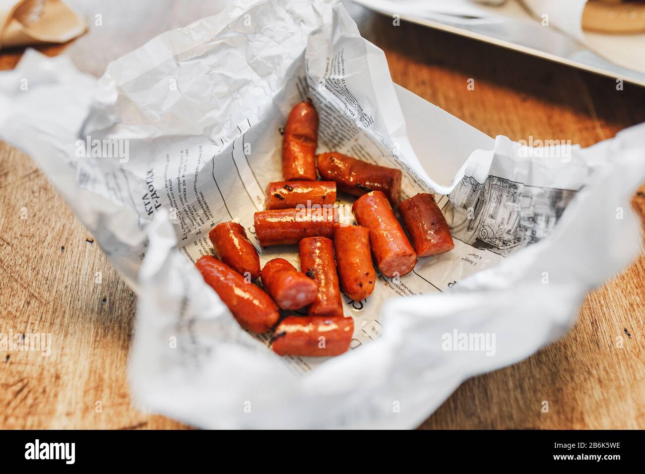 Appetizing grilled sausages with sauce on cafe table Stock Photo