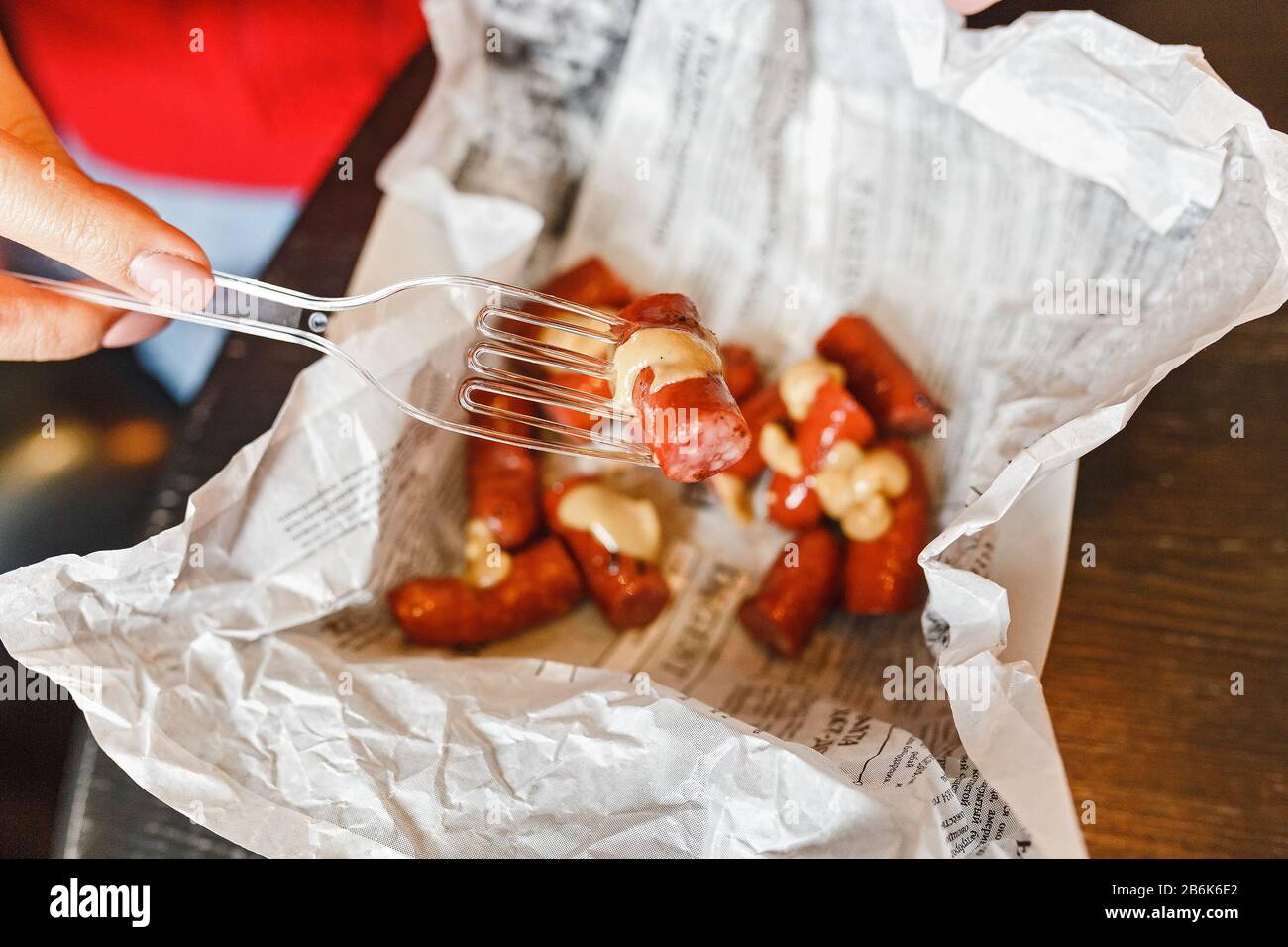 Appetizing grilled sausages with sauce on cafe table Stock Photo
