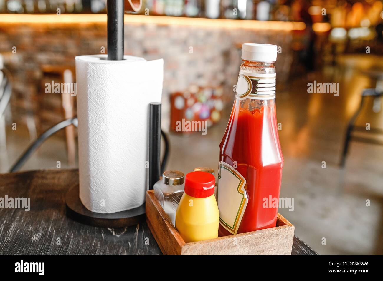 Ketchup and mustard in jars on the table in a burger snack bar or