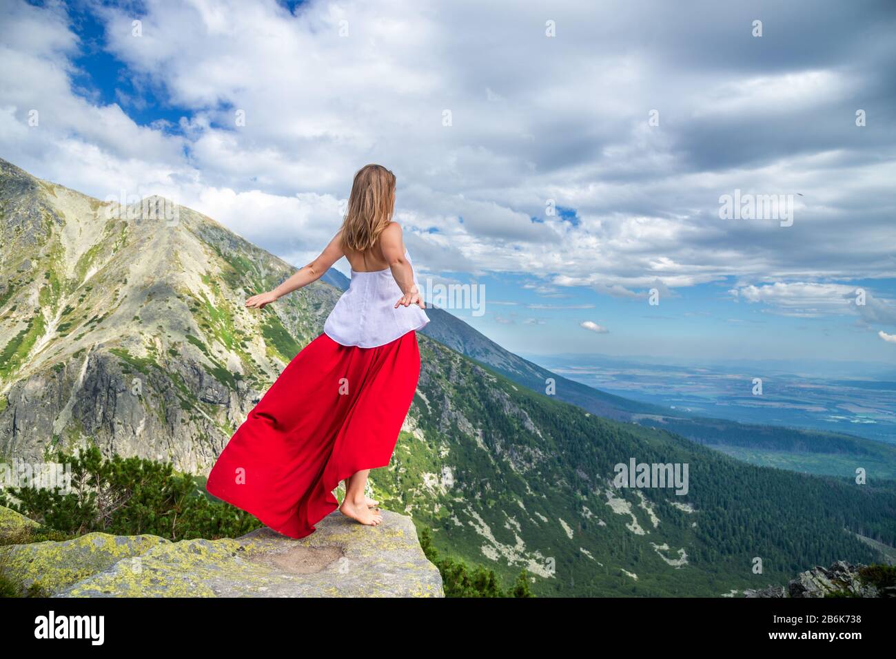 Young woman on the top of mountain Stock Photo - Alamy