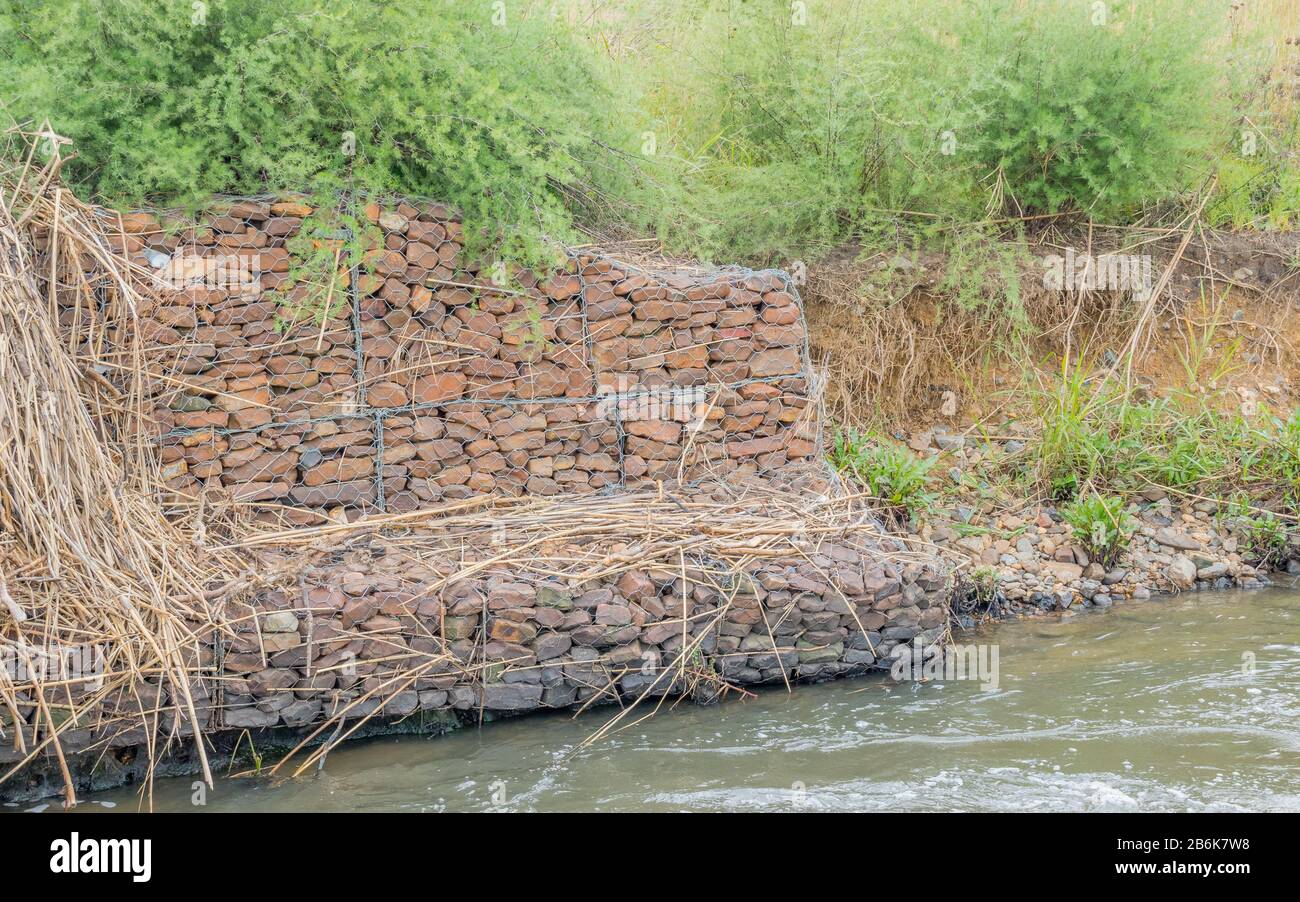 Gabion retaining walls to control erosion and flooding on the banks of