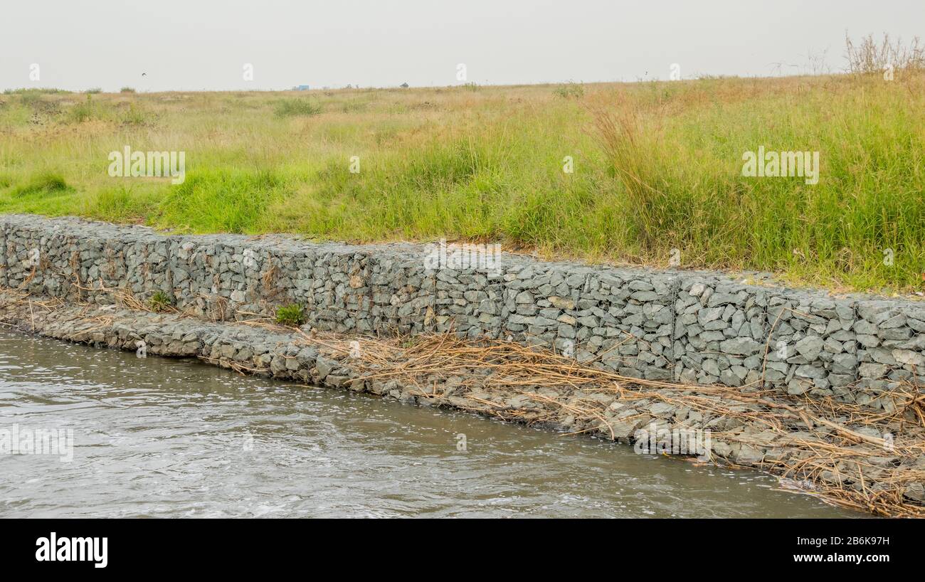 Gabion retaining walls to control erosion and flooding on the banks of