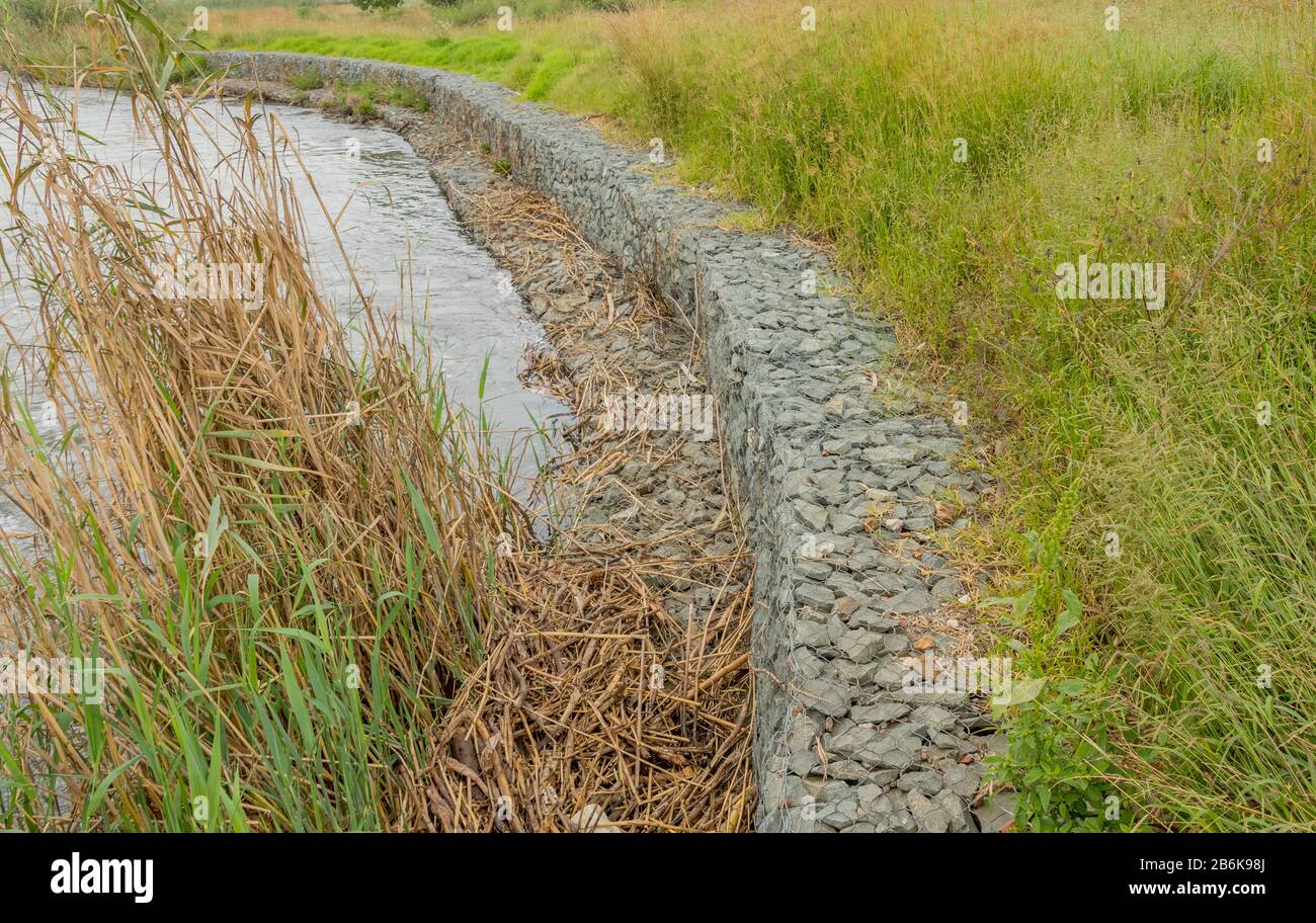 Gabion retaining walls to control erosion and flooding on the banks of