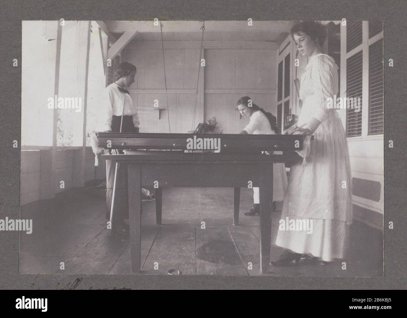 Three women playing billiards Three women playing billiards at Plantation Alliance. Left Maria Gonggrijp. Part of a group of eleven album pages with family photos of the family Gonggrijp in Suriname, approximately 1912. Manufacturer : Photographer: anonymous place manufacture: Suriname Date: 1910 - 1914 Material: paper Technique: Photography Dimensions: H 84 mm × W 118 mm Subject: billiardsWanneer: 1910 - 1915 Stock Photo