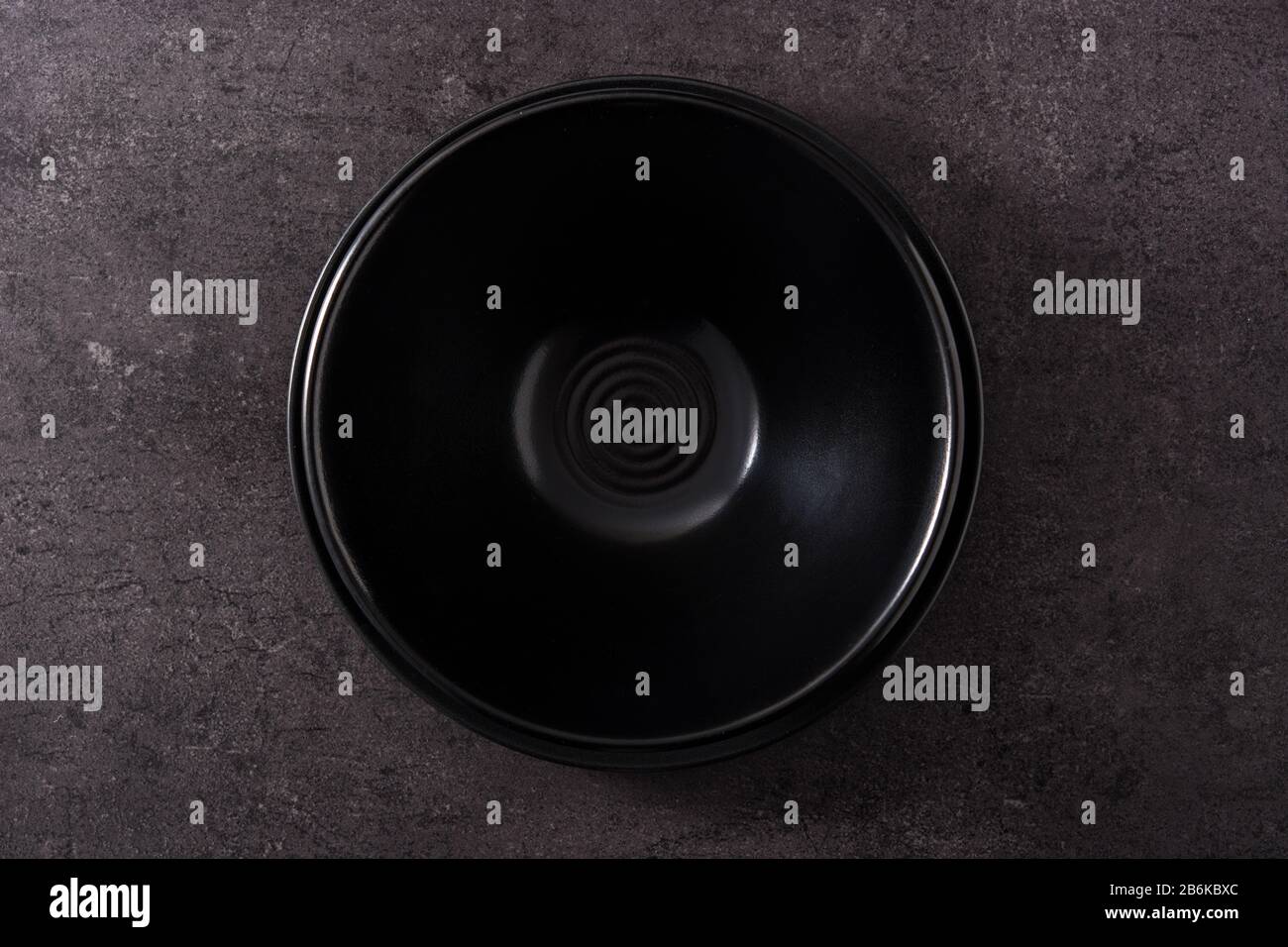 Empty black bowl on black slate background top view Stock Photo