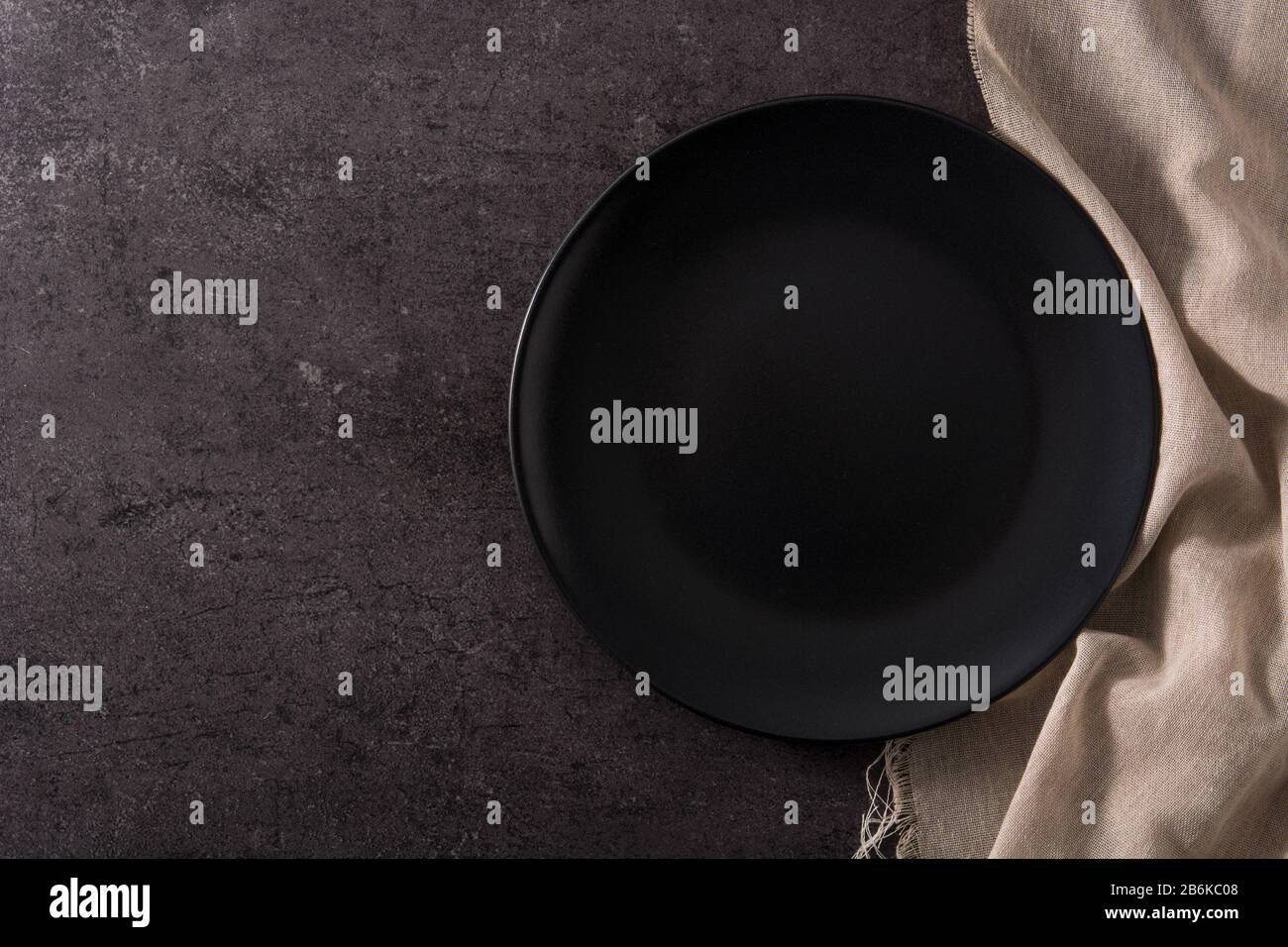 Empty black plate on black slate top view copy space Stock Photo