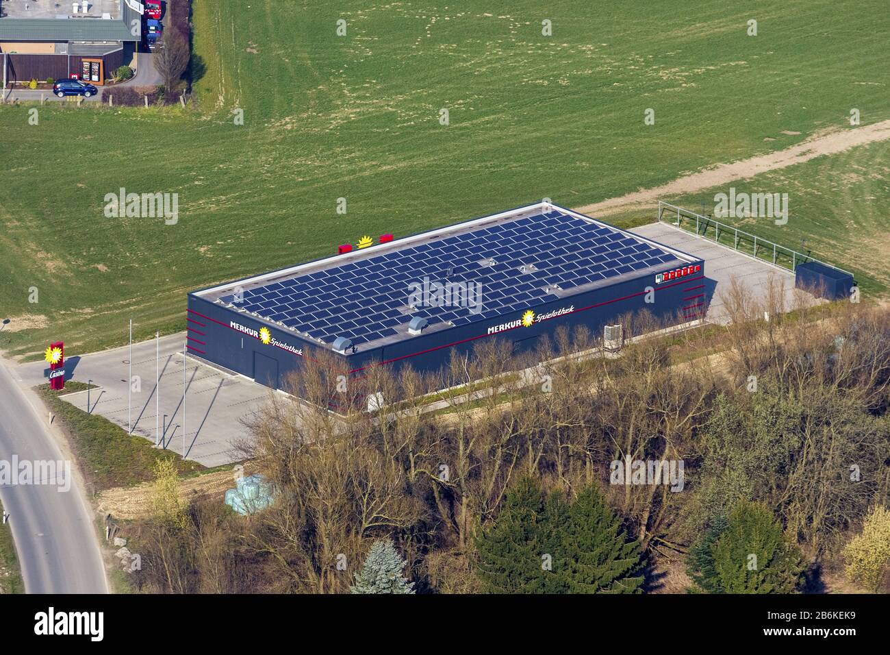 Casino Merkur gambling hall with solar panels or photovoltaic modules on the roof, at the street Haemmerstrasse in Menden, aerial view, Germany, North Rhine-Westphalia, Sauerland, Menden Stock Photo