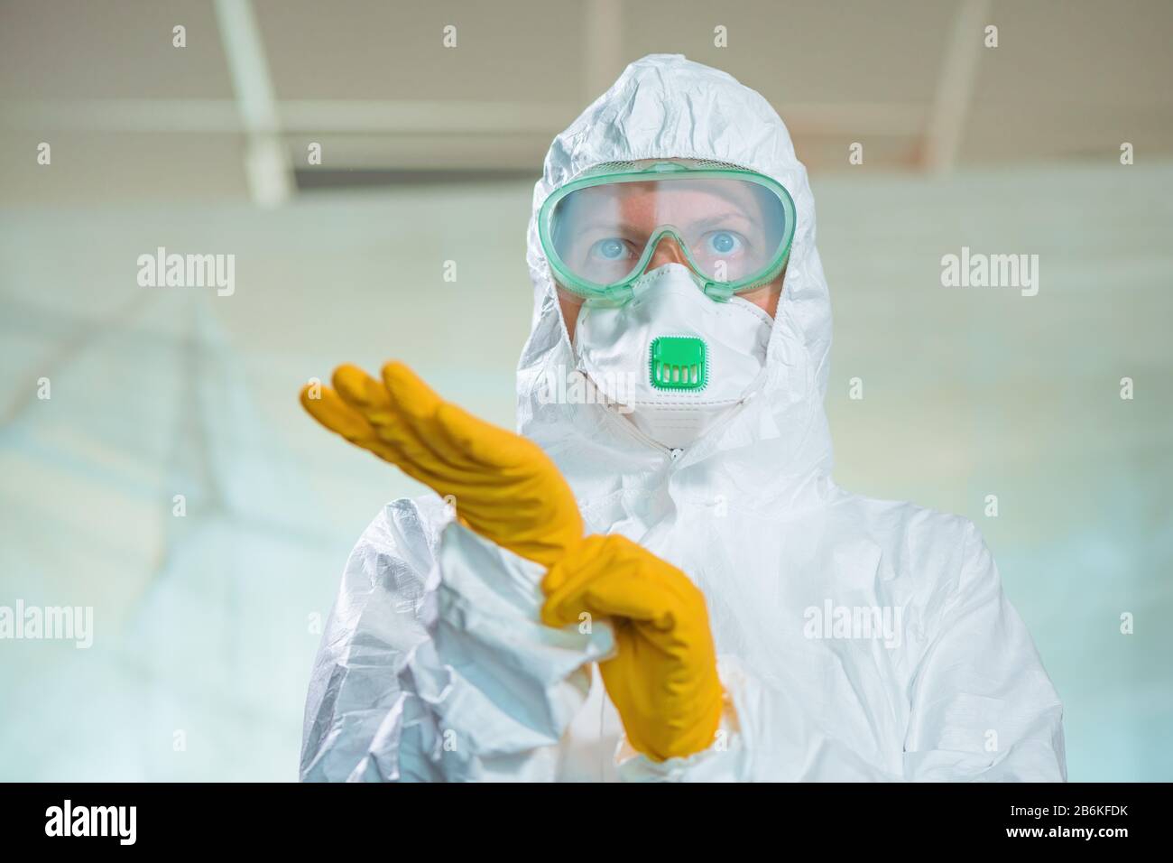 Portrait of female epidemiologist in virus quarantine, tight close up headshot of medical professional in protective clothing overalls Stock Photo