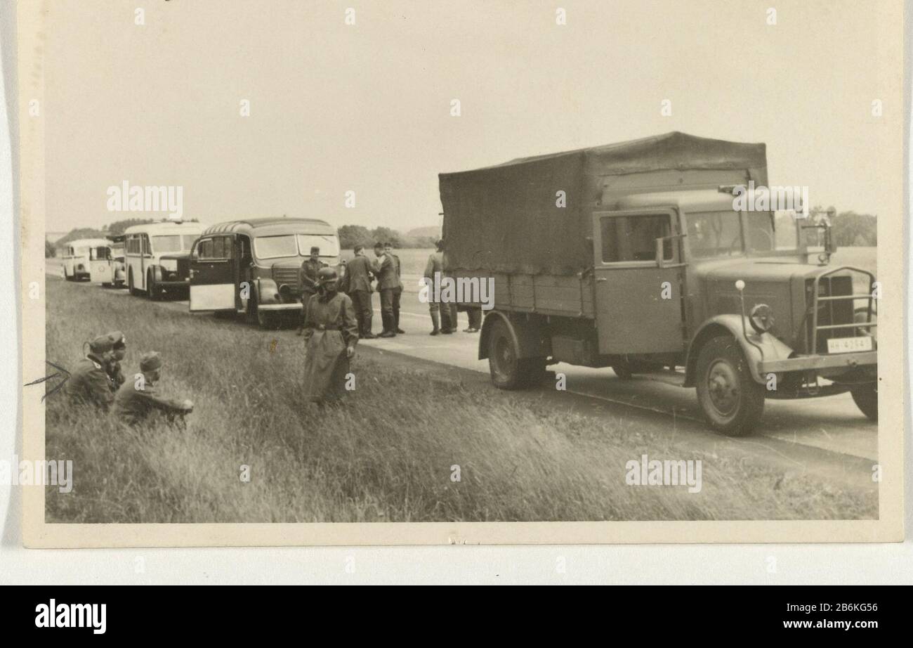 German soldiers in a truck German soldiers stand on a road with a truck and two buses. Three soldiers sitting in the grass. Back is: Die beiden Feldwebel am 16.6.40. Manufacturer : Photographer: anonymous place manufacture: Netherlands (possible) Dated: Jun 16 1940 Physical features: gelatin silver print material: paper Technique: gelatin silver print Dimensions: H 6 cm. B × 9 cm.  Subject: occupation  war troop movements, transportation War II Occupation of Netherlands When: 1940 - 1940 Stock Photo