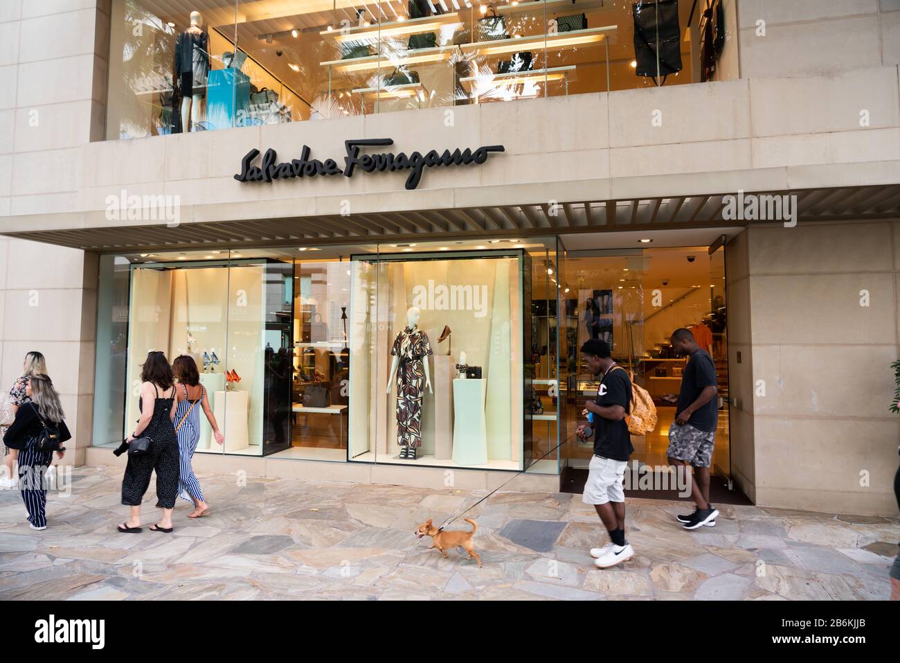 Pedestrians walk past an Italian luxury goods high-end retailer Salvatore Ferragamo store. Stock Photo