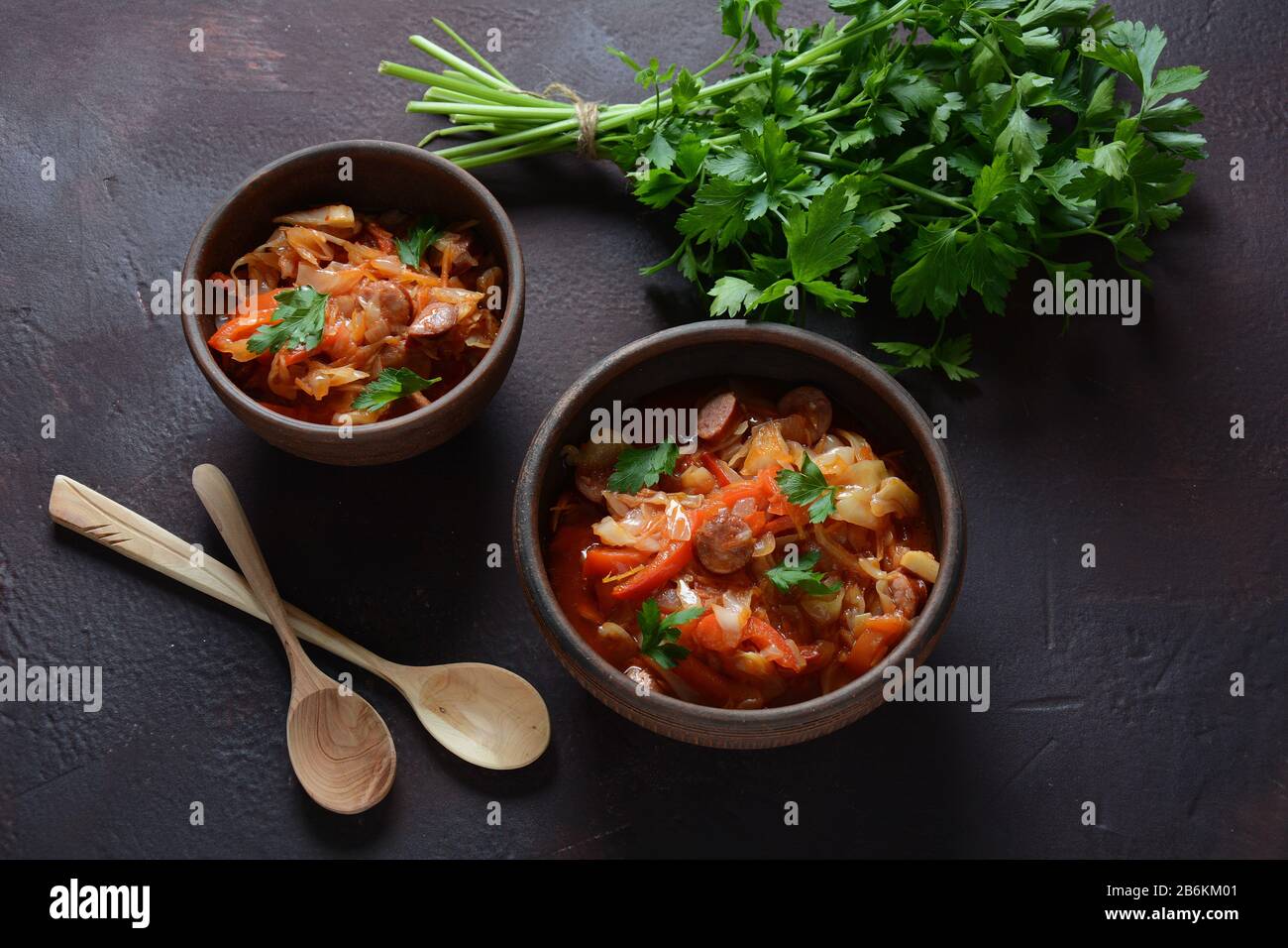 Cabbage stew with grilled sausage in tomato sauce traditional dish of