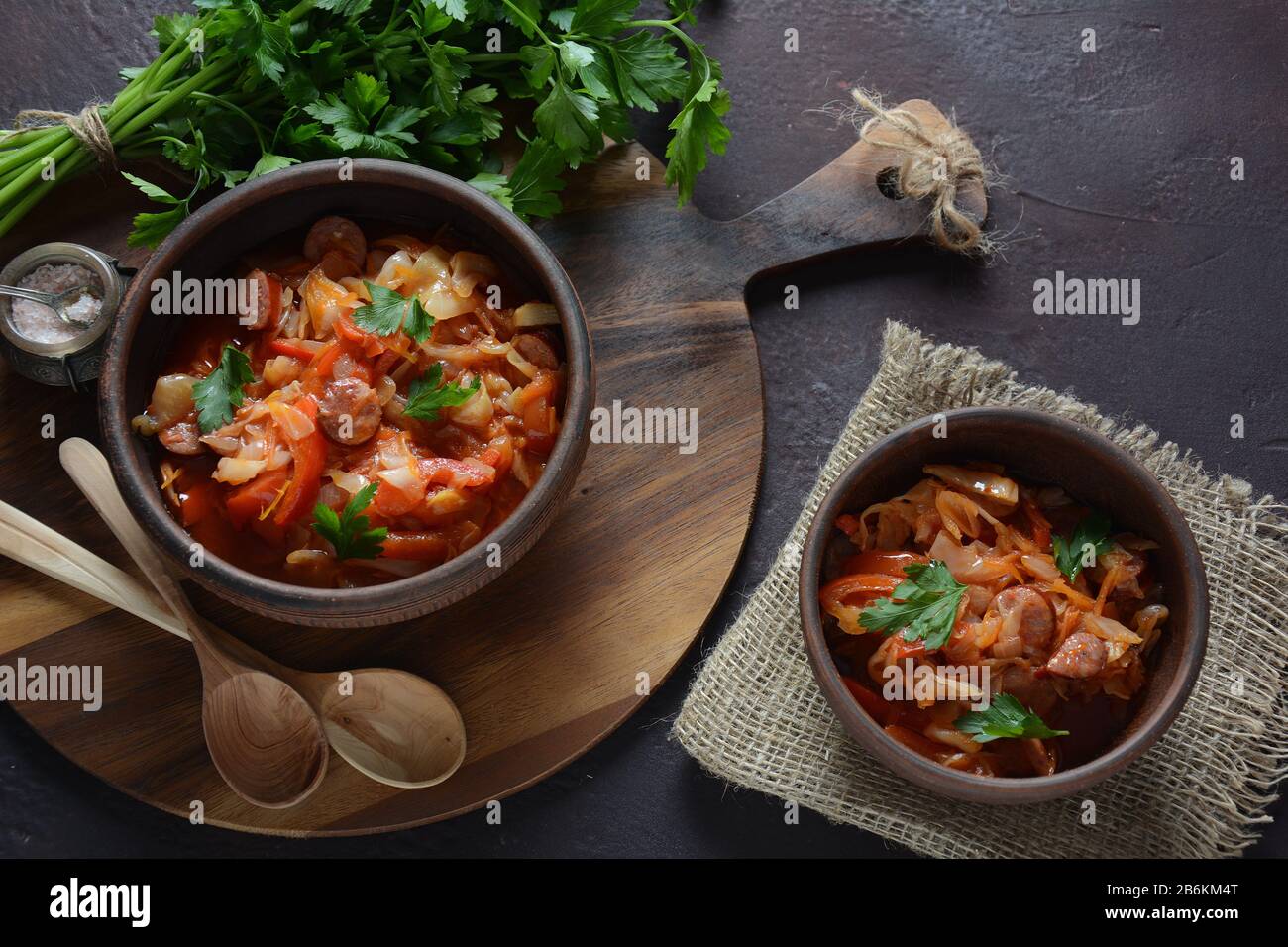 Cabbage stew with grilled sausage in tomato sauce traditional dish of German, Polish or