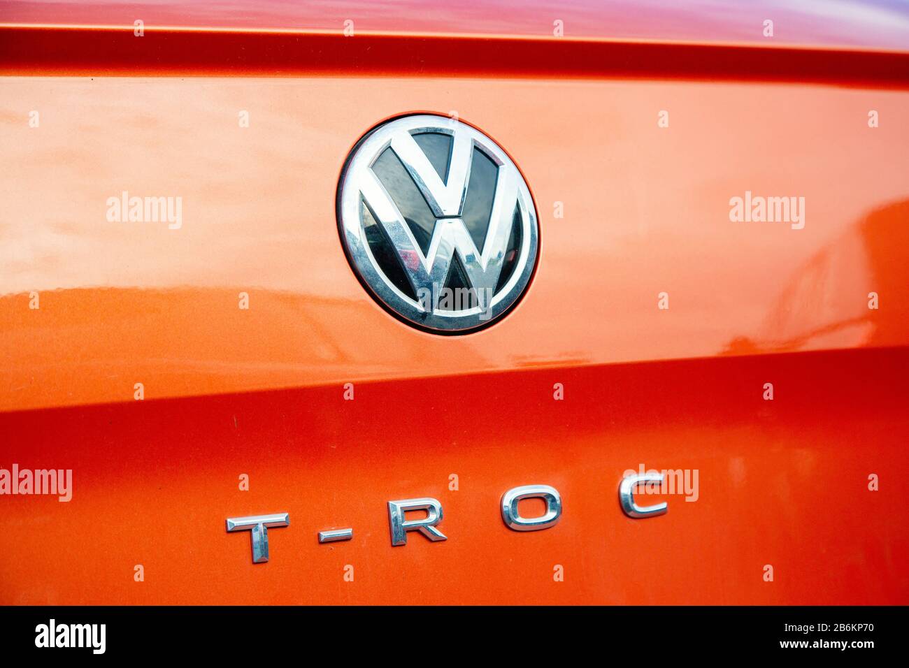 Cognac, France - February 16, 2020:Close-up of the Logo T-Roc placed on the back of orange Volkswagen SUV car Stock Photo