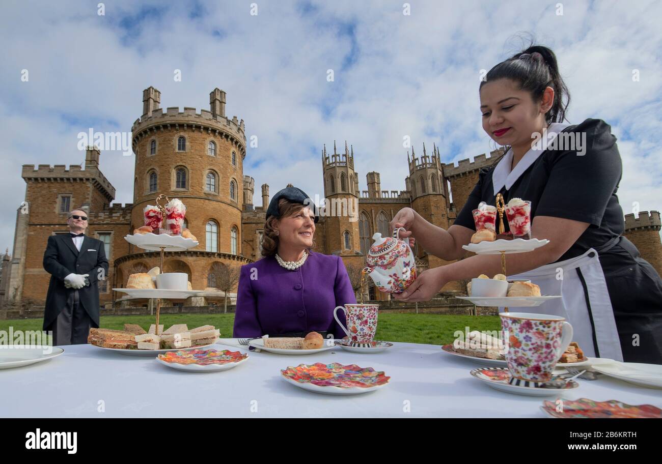 Emma Manner, Duchess of Rutland (centre), is served tea by Lliana Dimitrove, during the launch event for a Royal Afternoon Tea inspired by Netflix's The Crown, at Belvoir Castle, Grantham. Stock Photo