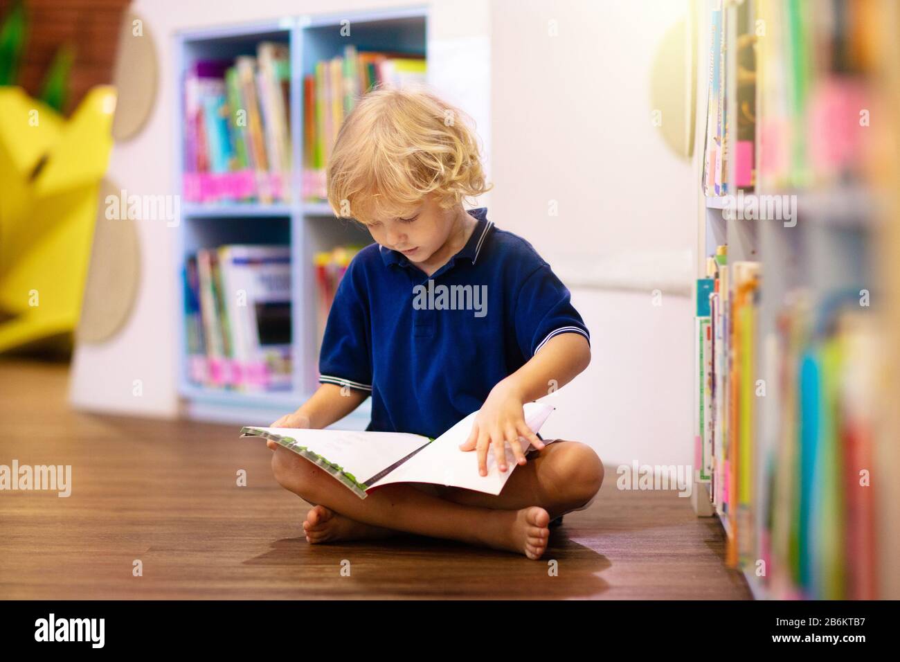 Child in school library. Kids read books. Little boy reading and studying.  Children at book store. Smart intelligent preschool kid choosing books to b  Stock Photo - Alamy