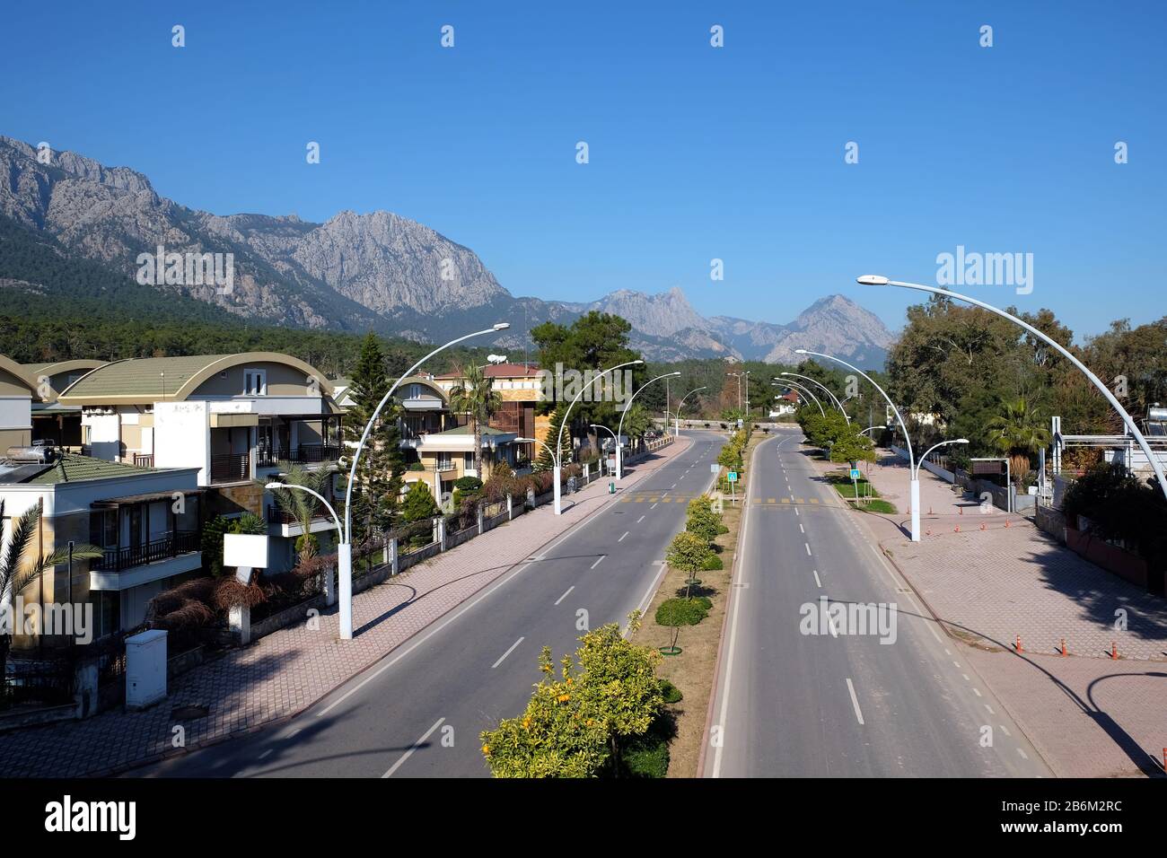 Ataturk Boulevard in Kemer with hotels buildings and Taurus mountains at far on a bright sunny day Stock Photo
