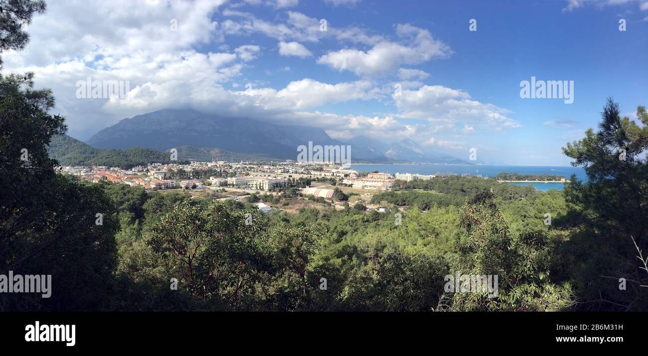 Ataturk Boulevard in Kemer with hotels buildings and Taurus mountains at far on a bright sunny day Stock Photo